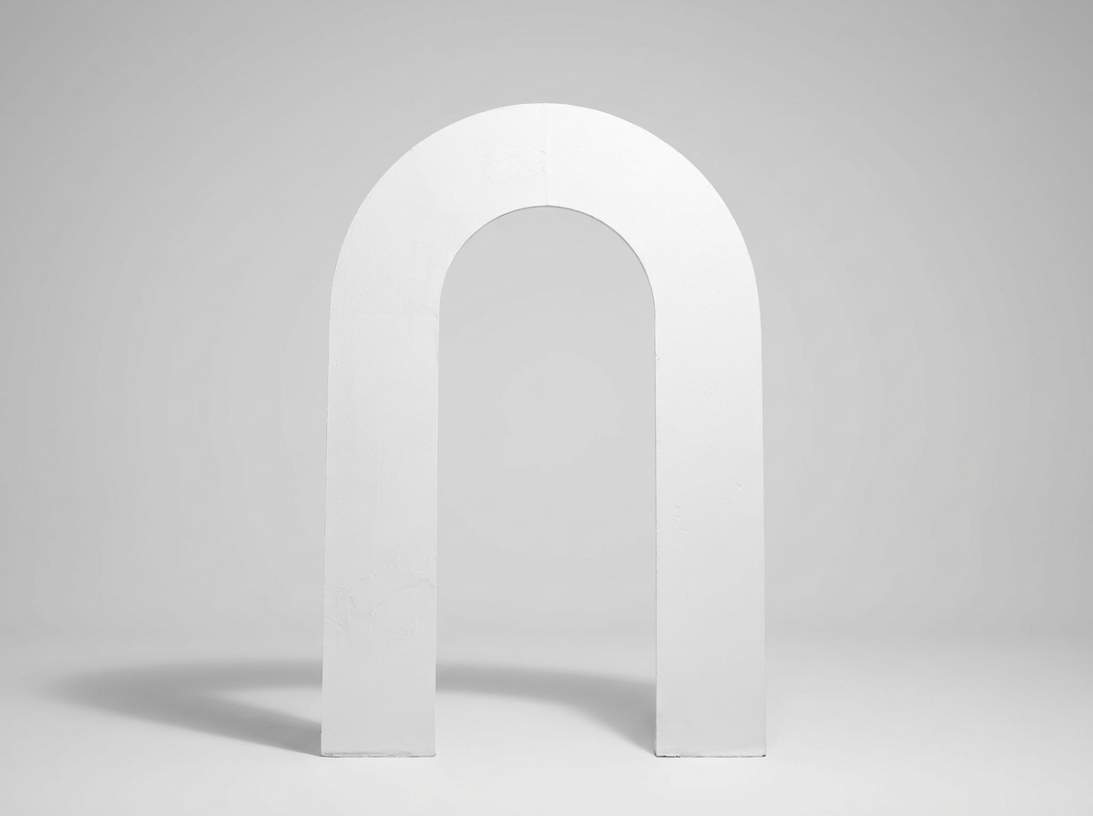 A white, freestanding letter 'n' with a rounded arch shape, set against a plain gray background.