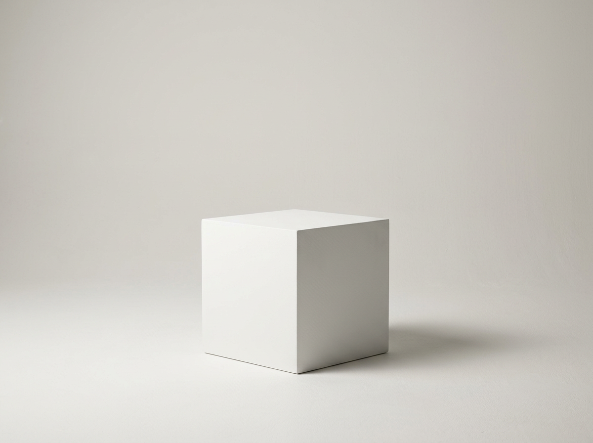 Solid white cube on a light gray surface with a neutral background.
