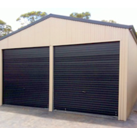 A beige storage shed with two black roll-up garage doors and a sloped roof.