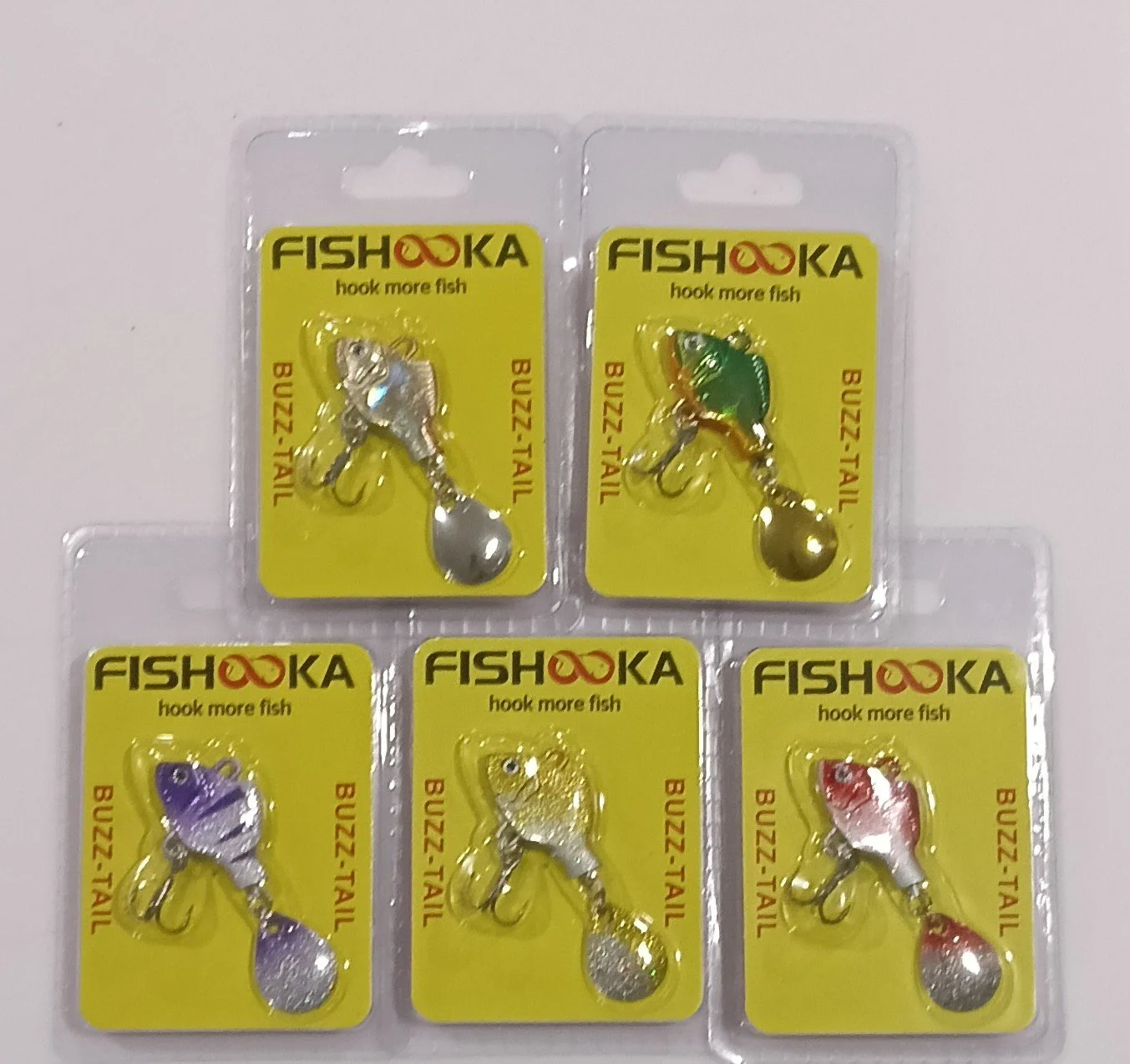 Set of fishing lures in packaging, labeled 'FISHOKA', with various fish-shaped designs and colors.