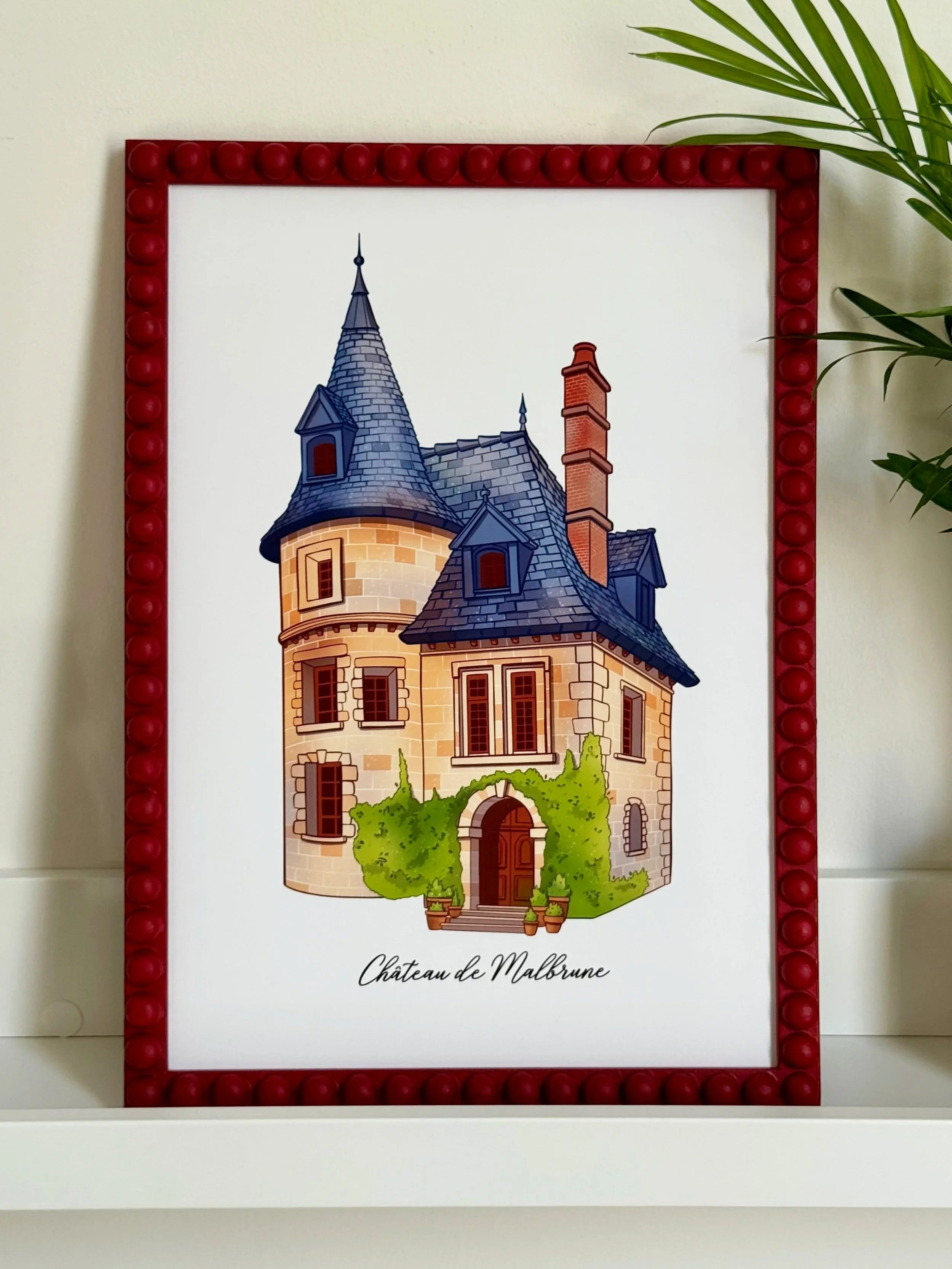 Illustration of Château de Malbrune, a castle with a stone facade, pointed turrets, a chimney, and greenery at the entrance, framed in a red border with a plant on the side.