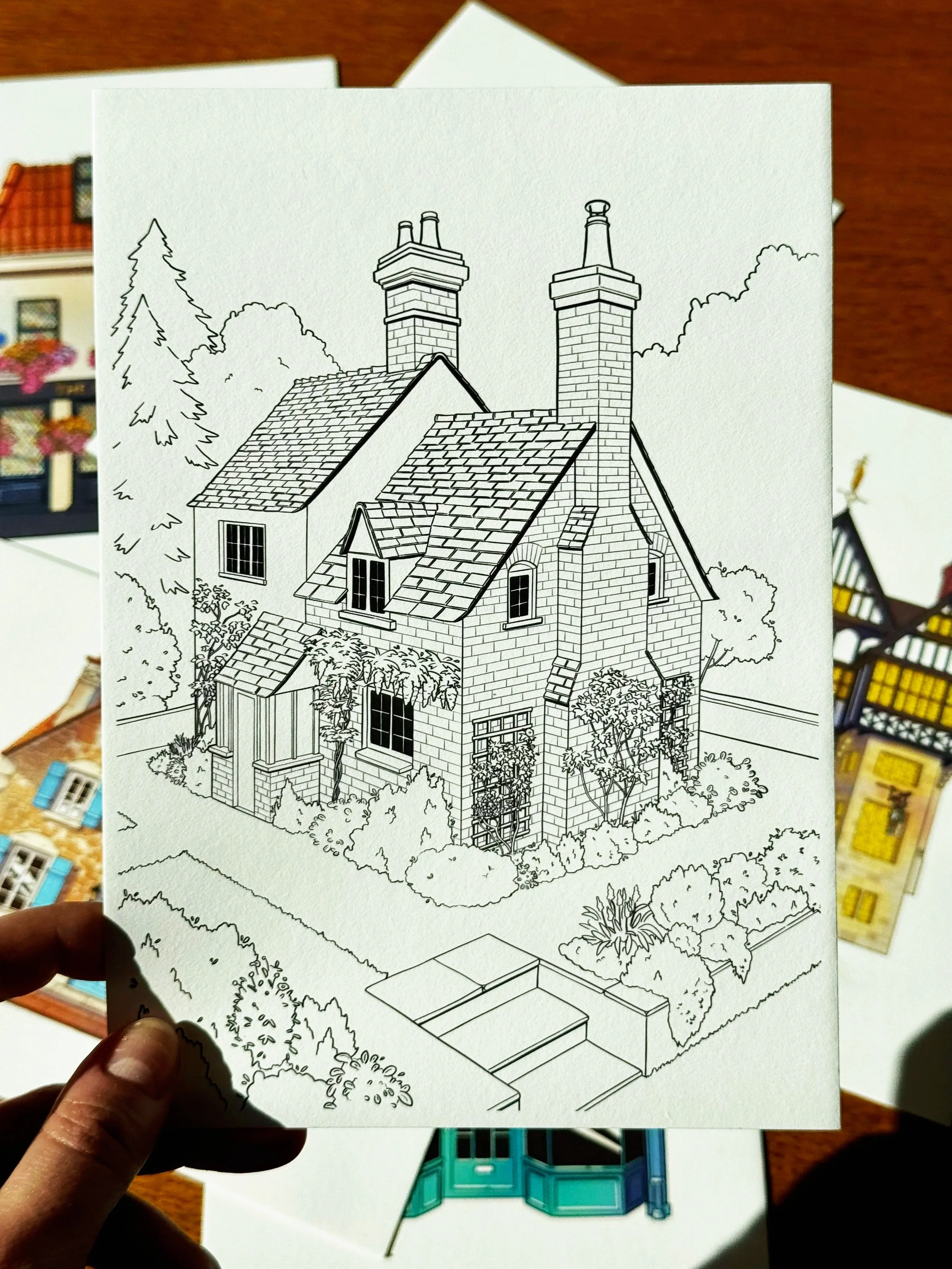 A black-and-white line drawing of a house with multiple chimneys, surrounded by trees and bushes, with steps leading up to the front entrance.