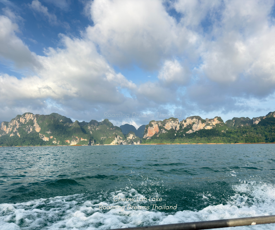 Cruising through the iconic limestone formations of Cheow Lan Lake aboard a longtail boat.