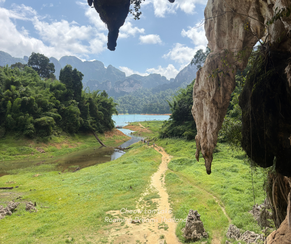 A breathtaking frame of nature—viewing the emerald lake from inside a cave trail.