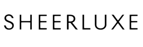 The word 'SHEERLUXE' in bold black letters on a black background with white speckles.