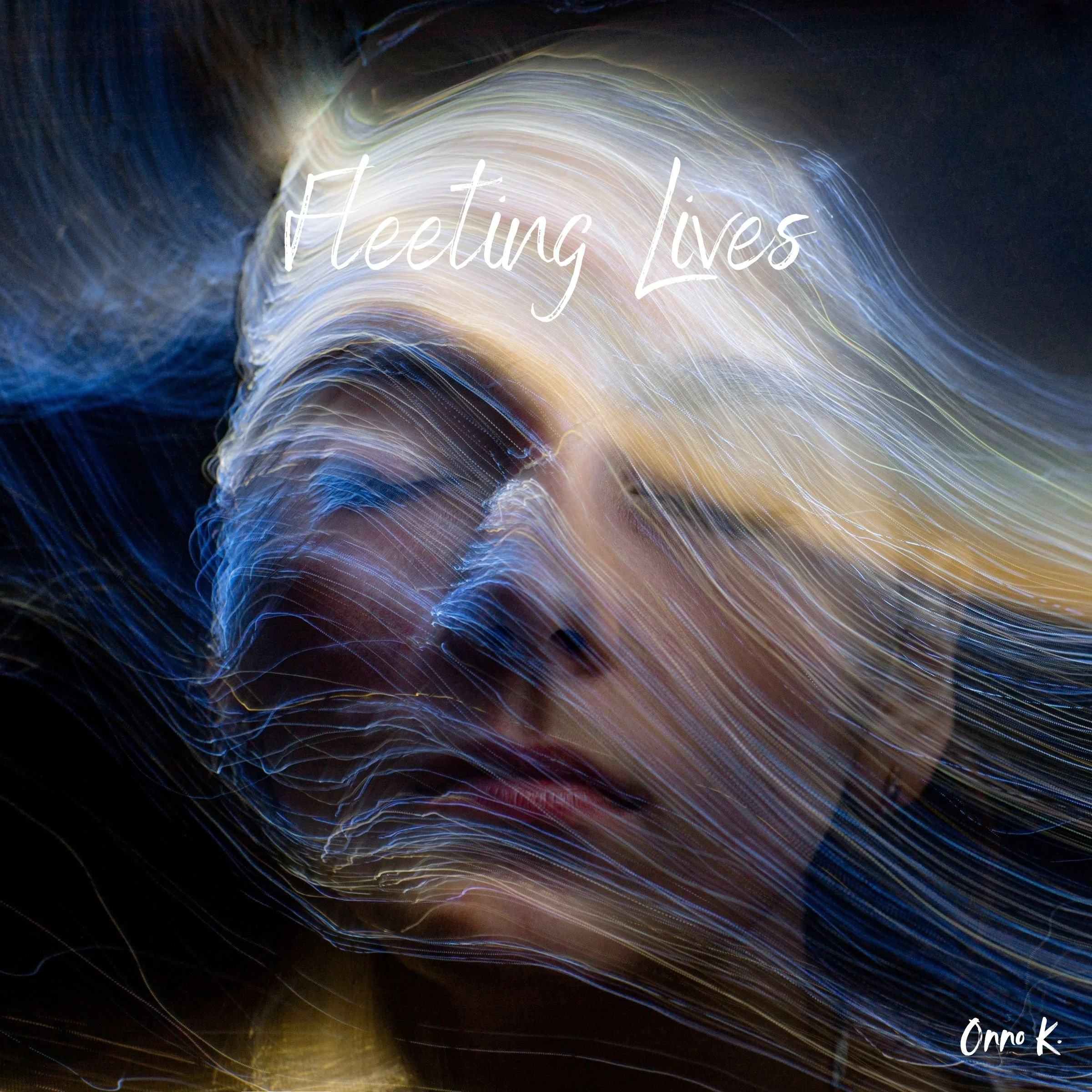Abstract light streaks in various colors with the text 'Meeting Lives' written in white cursive font and a signature 'Onna K.' in the bottom right corner.