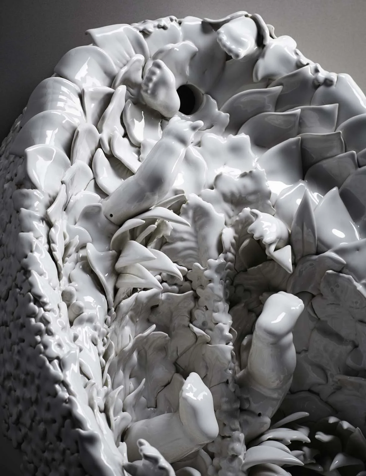 Close-up of a white sculpture featuring abstract, organic shapes and forms.