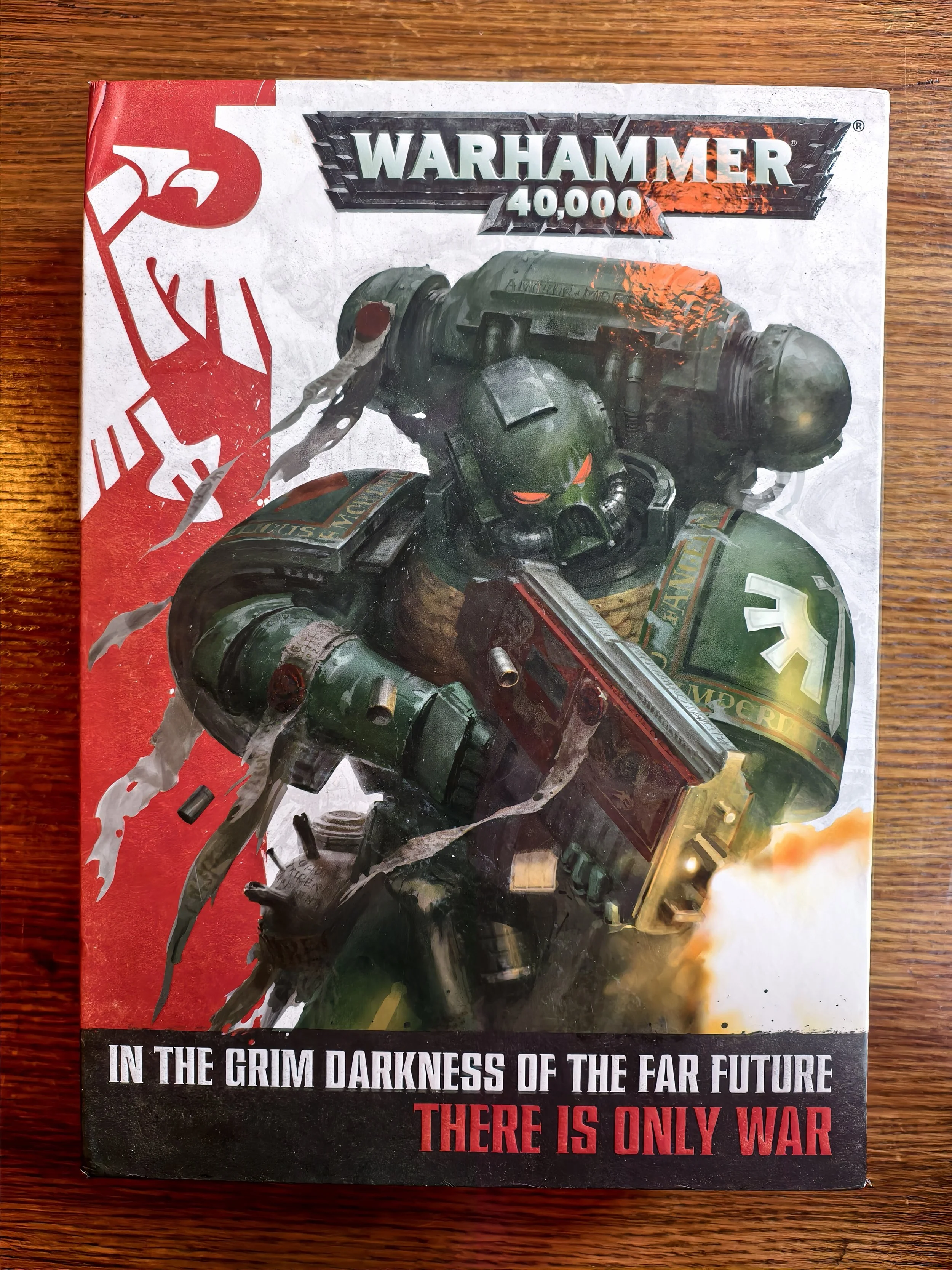 A book cover featuring a soldier in green armor holding a weapon, with intense flames and smoke. The title is "Warhammer 40,000" and the subtitle reads "In the grim darkness of the far future, there is only war."