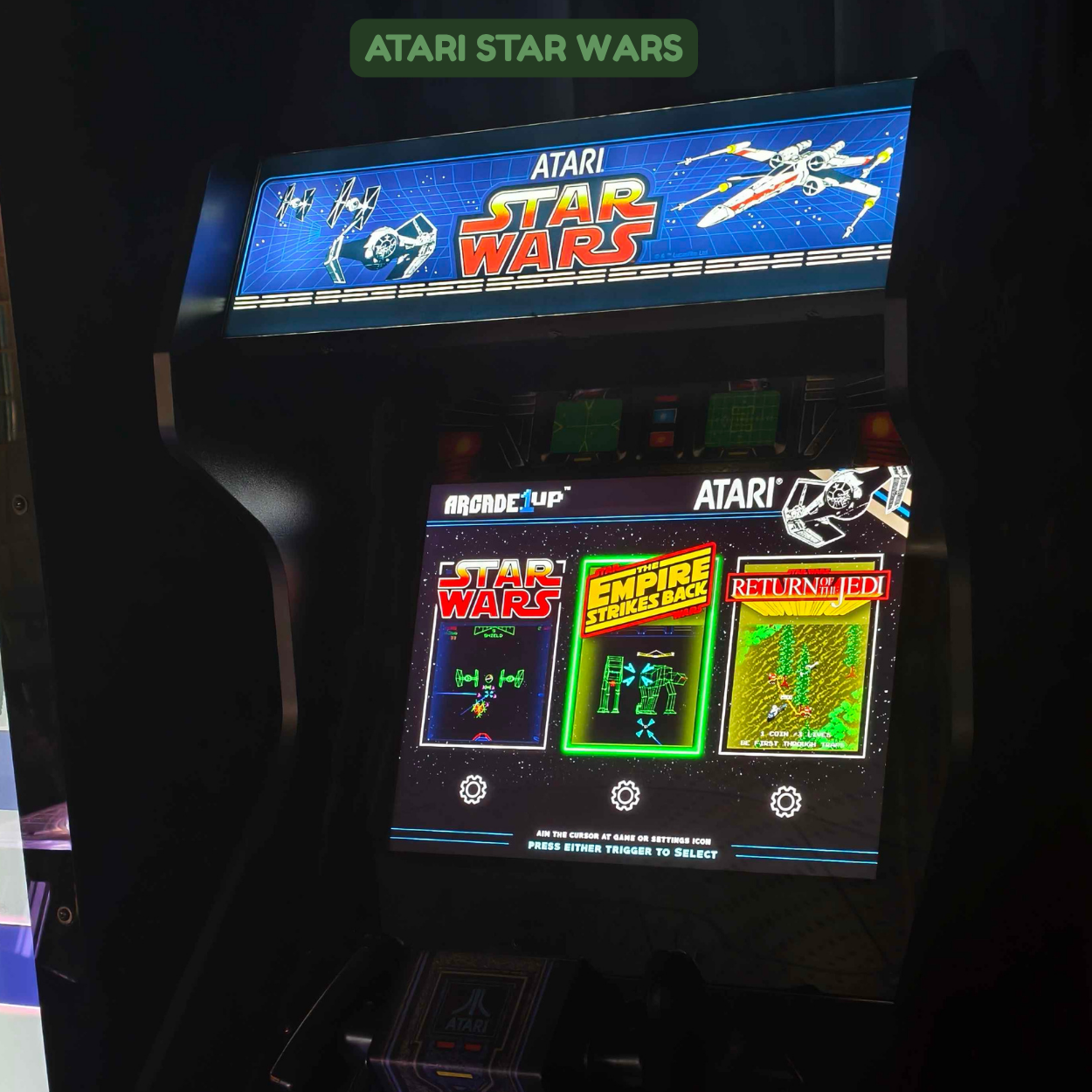 Arcade game screen featuring classic Atari Star Wars video game, with game title and related graphics