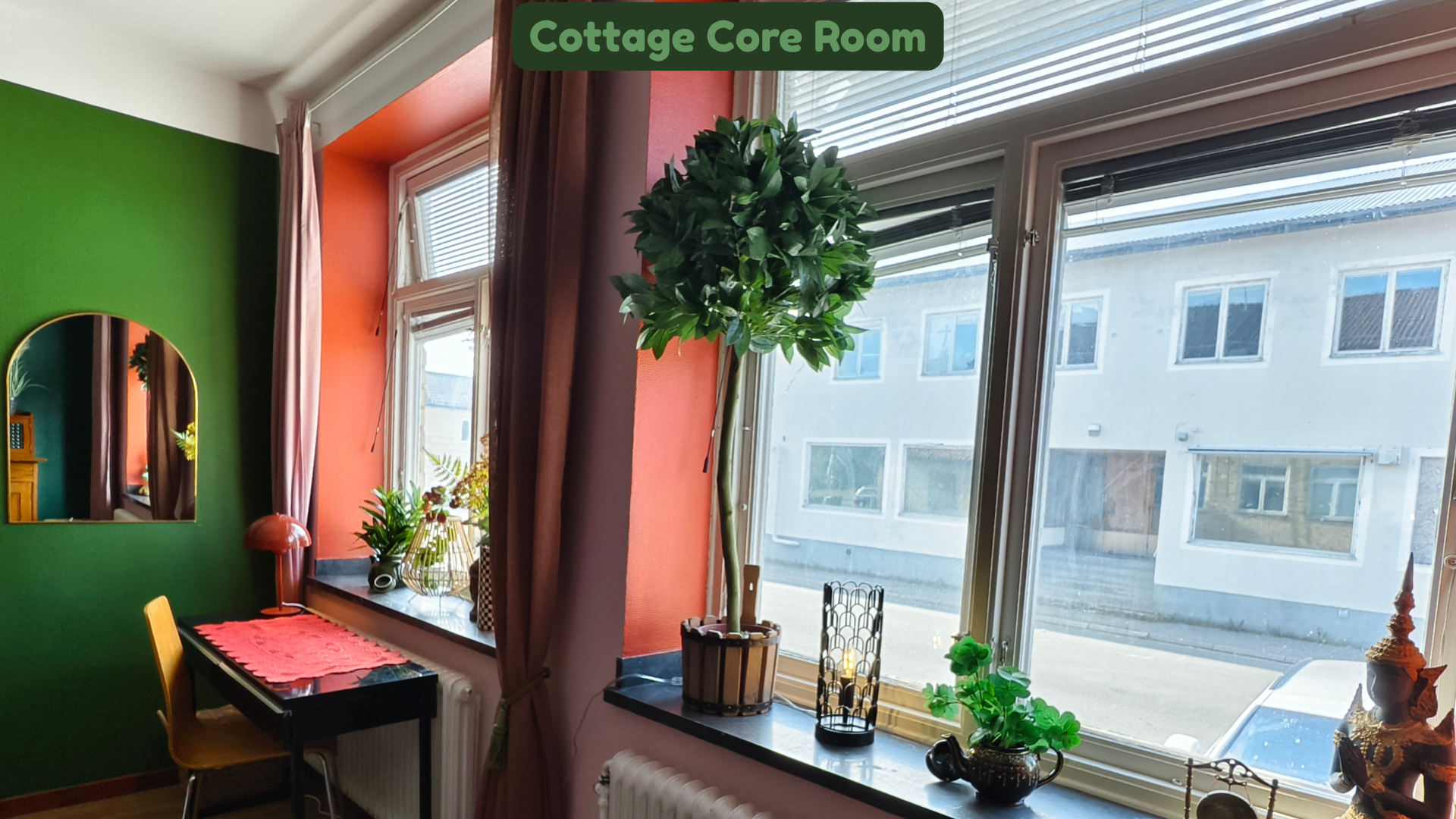 Indoor scene from the Cottage Core Room with a large window and a potted plant. Decor includes colorful walls, a mirror, and various decorative items on the windowsill and surrounding area.