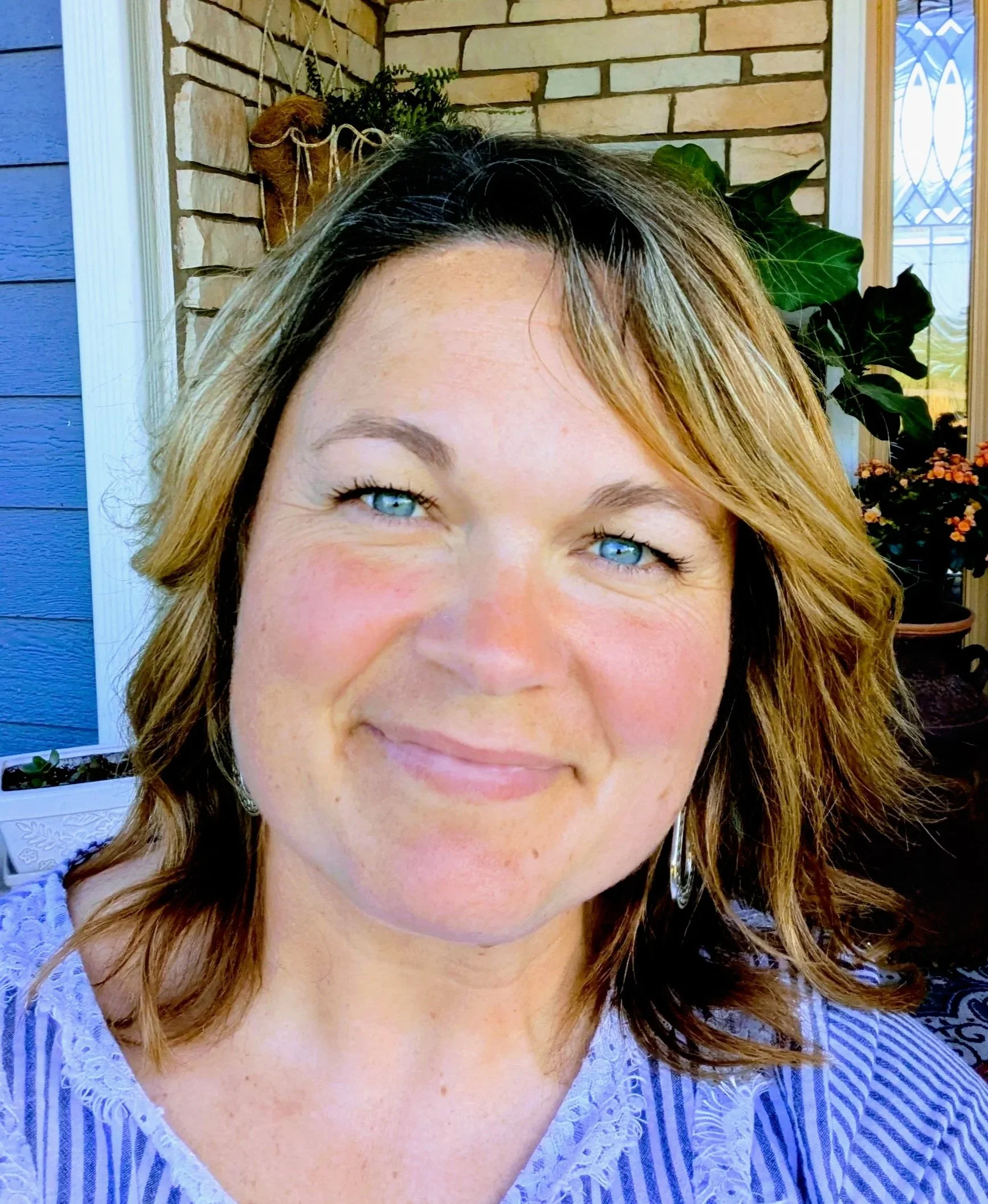 Crystal sitting on her front porch with a warm, relaxed smile