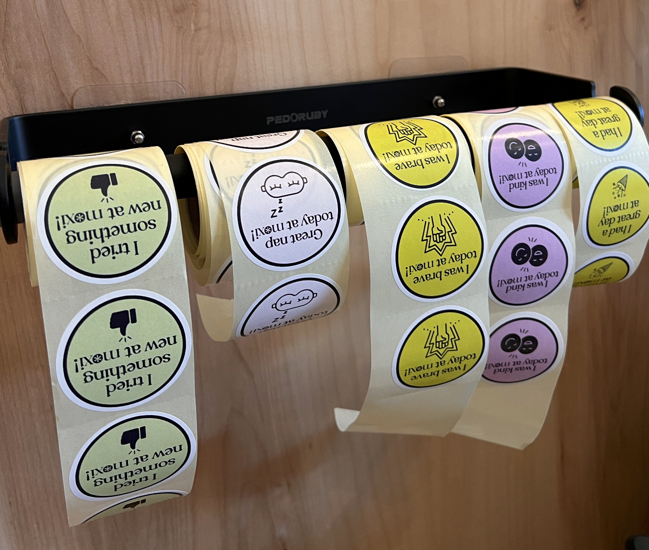 Stickers hanging from a bar, with different achievements. Such as "Great nap" and "I was kind today!"