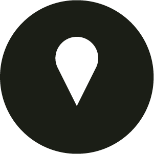 Black circle with a white location pin icon in the centre.