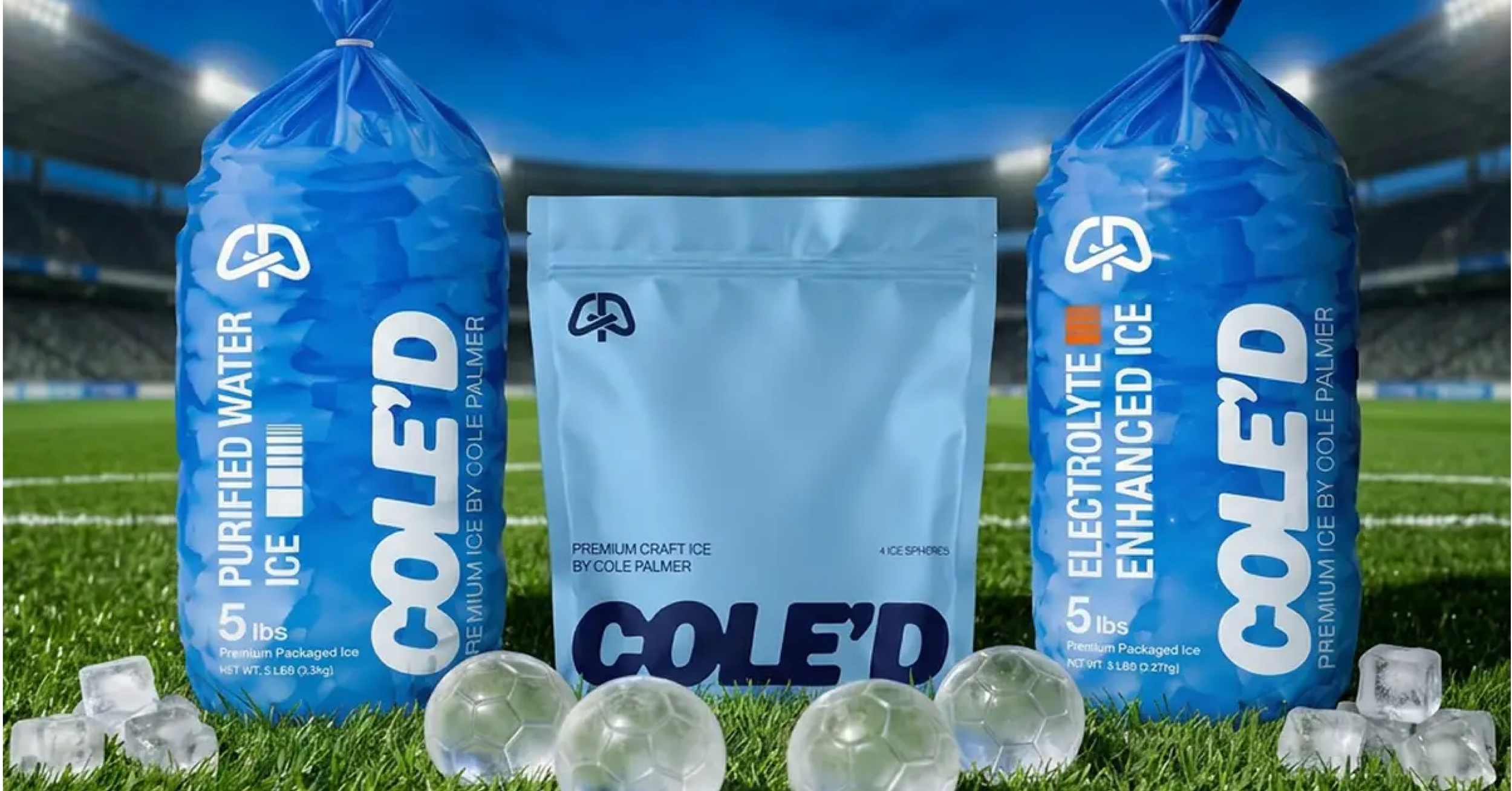 Two 5-pound bags of Cole Palmer's premium packaged ice flanking a sealed bag of ice spheres on a soccer field with Chelsea FC stadium seating in the background.