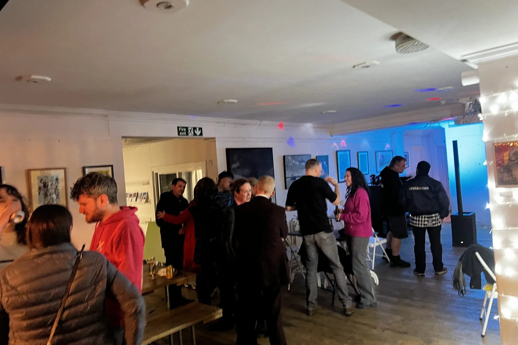 A relaxed crowd standing and chatting with drinks at Open Decks at Chapel Allerton Arts Centre, Leeds