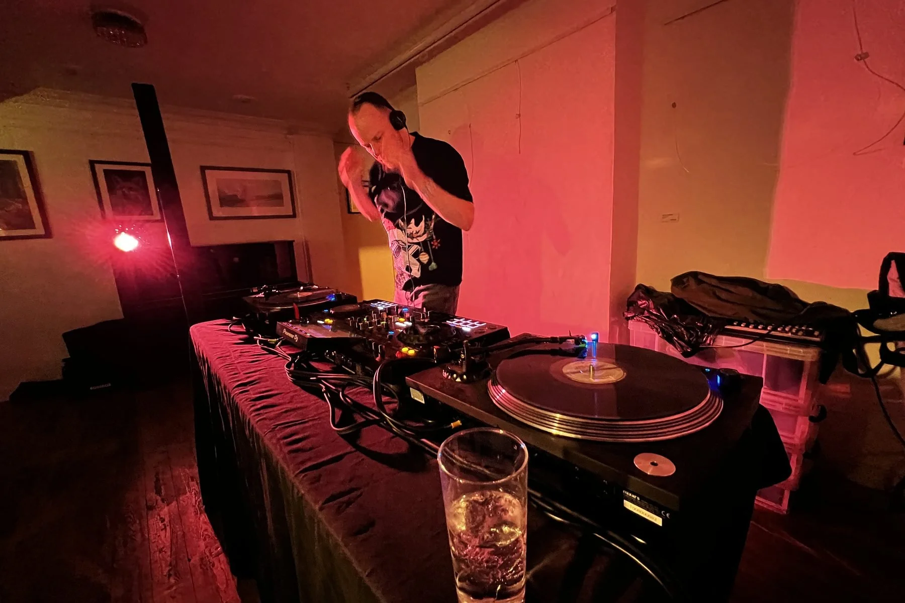 Vinyl spinning on turntables beside a drink at Open Decks at Chapel Allerton Arts Centre, Leeds