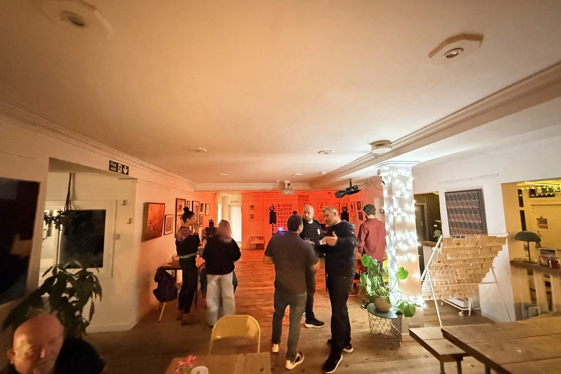 The gallery and cafe bar at Chapel Allerton Arts Centre in Leeds with people gathering during an evening event