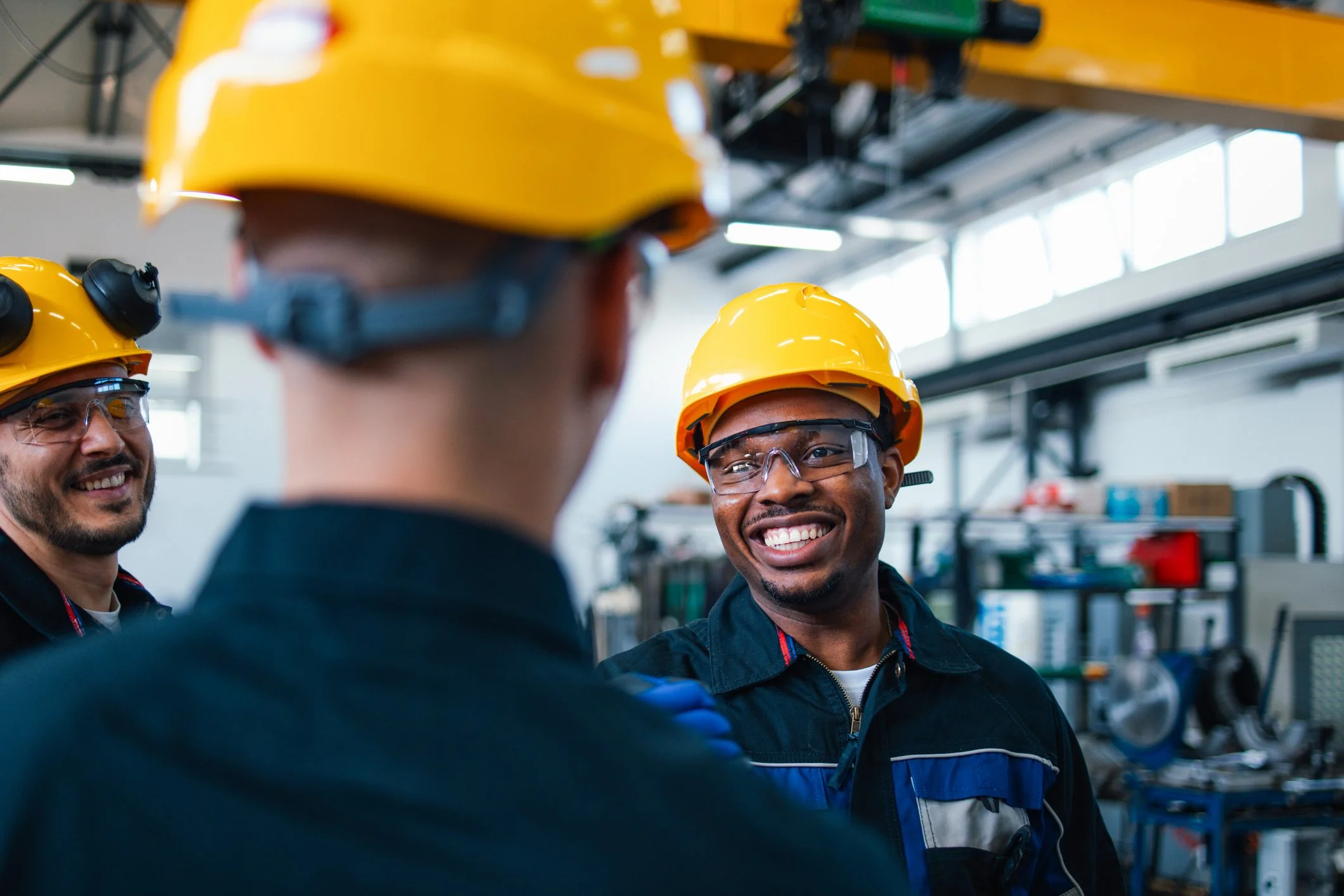 Manufacturing professionals collaborating in an industrial facility to support operations, processes, and team performance.
