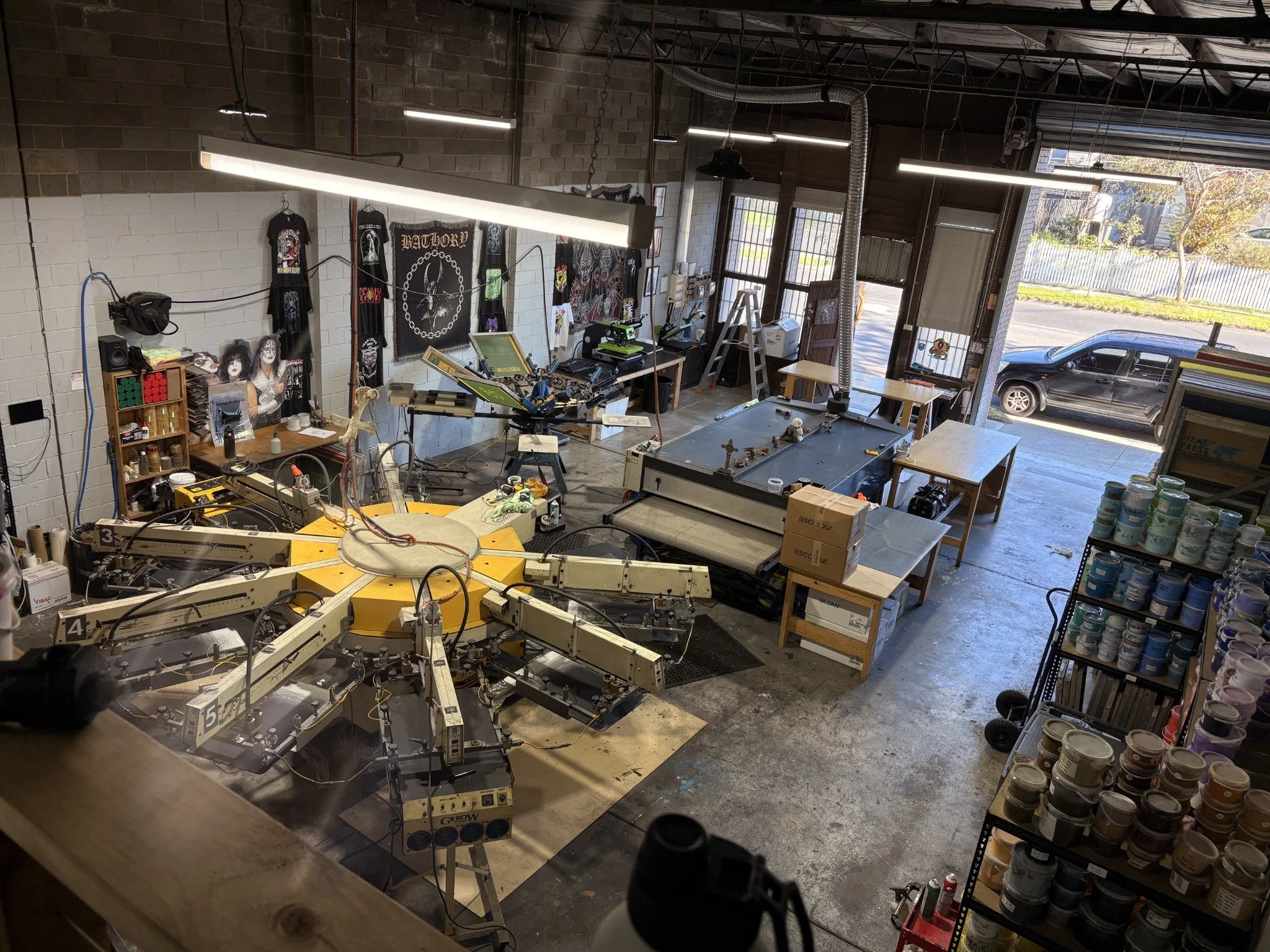 Automatic press and printed shirts inside Tee It Up’s Coburg North workshop.