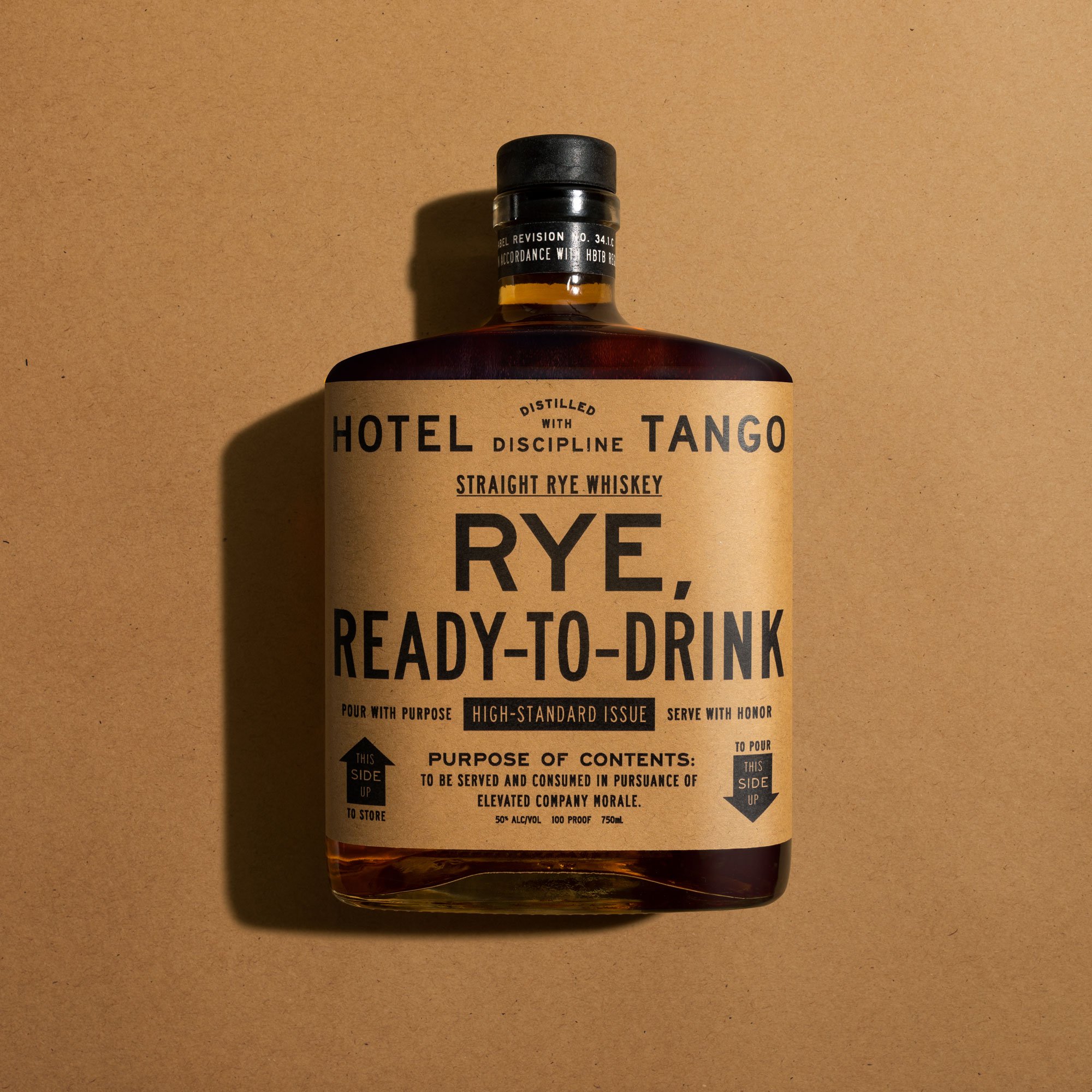 Bottle of Hotel Tango straight rye whiskey on a beige background with shadows.