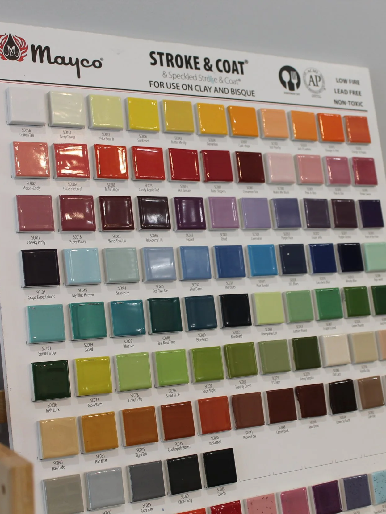 Color swatch palette for ceramic and clay glazes, with rows of various colored glaze samples labeled with names and codes.