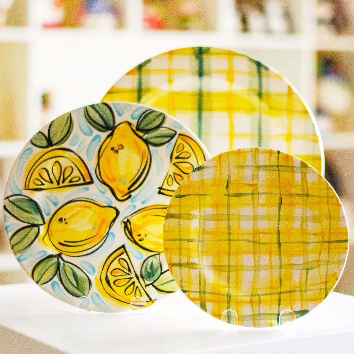 Decorative glass plates with lemon and lemon slice illustrations and yellow plaid patterns.