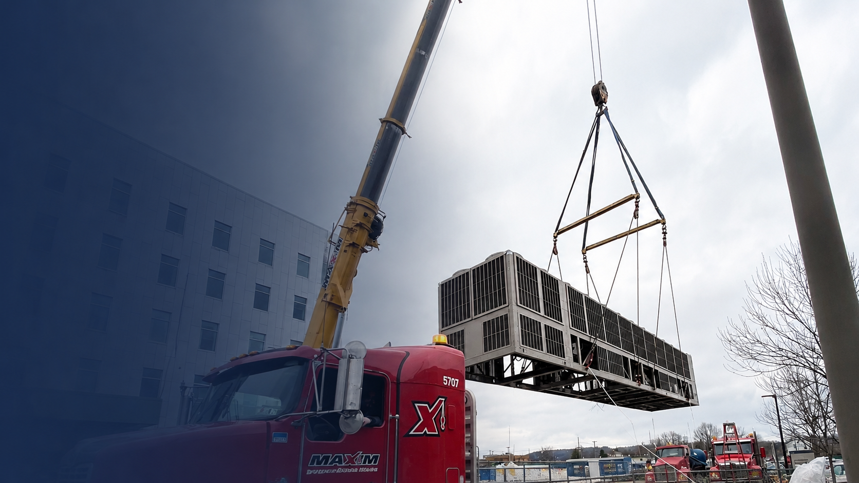 Commercial HVAC rooftop equipment installation using a crane.