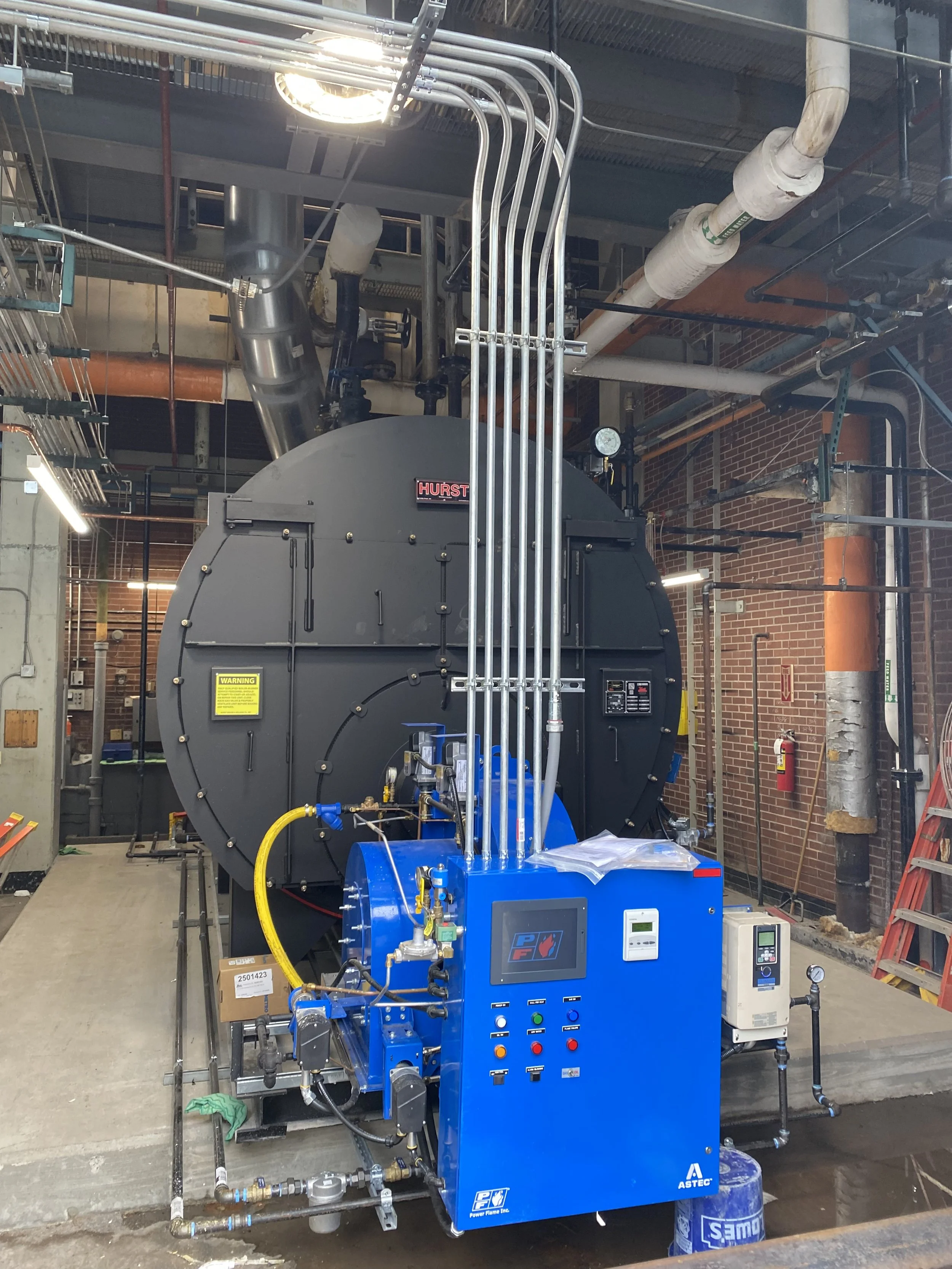 Commercial boiler installation with piping, controls and related mechanical equipment.