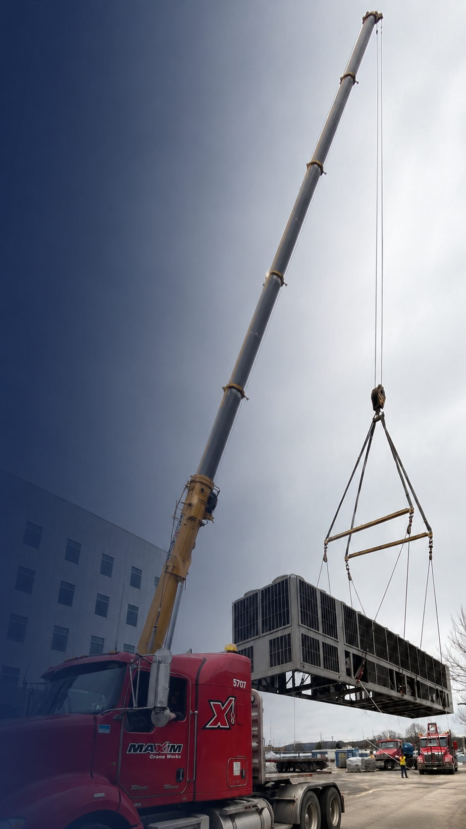 Commercial HVAC equipment being lifted into place by crane.