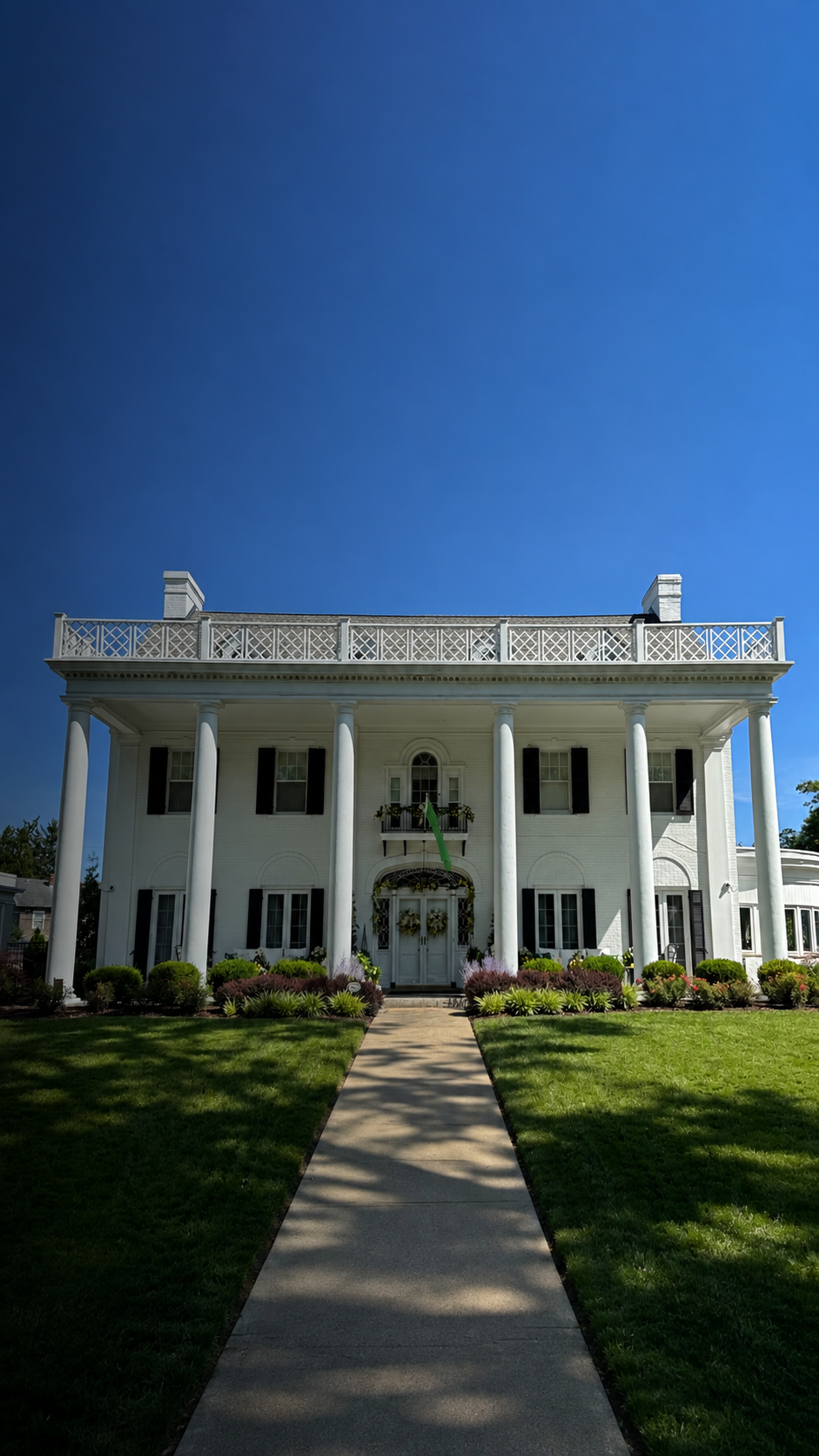 Marshall University President's House in Huntington, West Virginia, with white columns and black shutters.