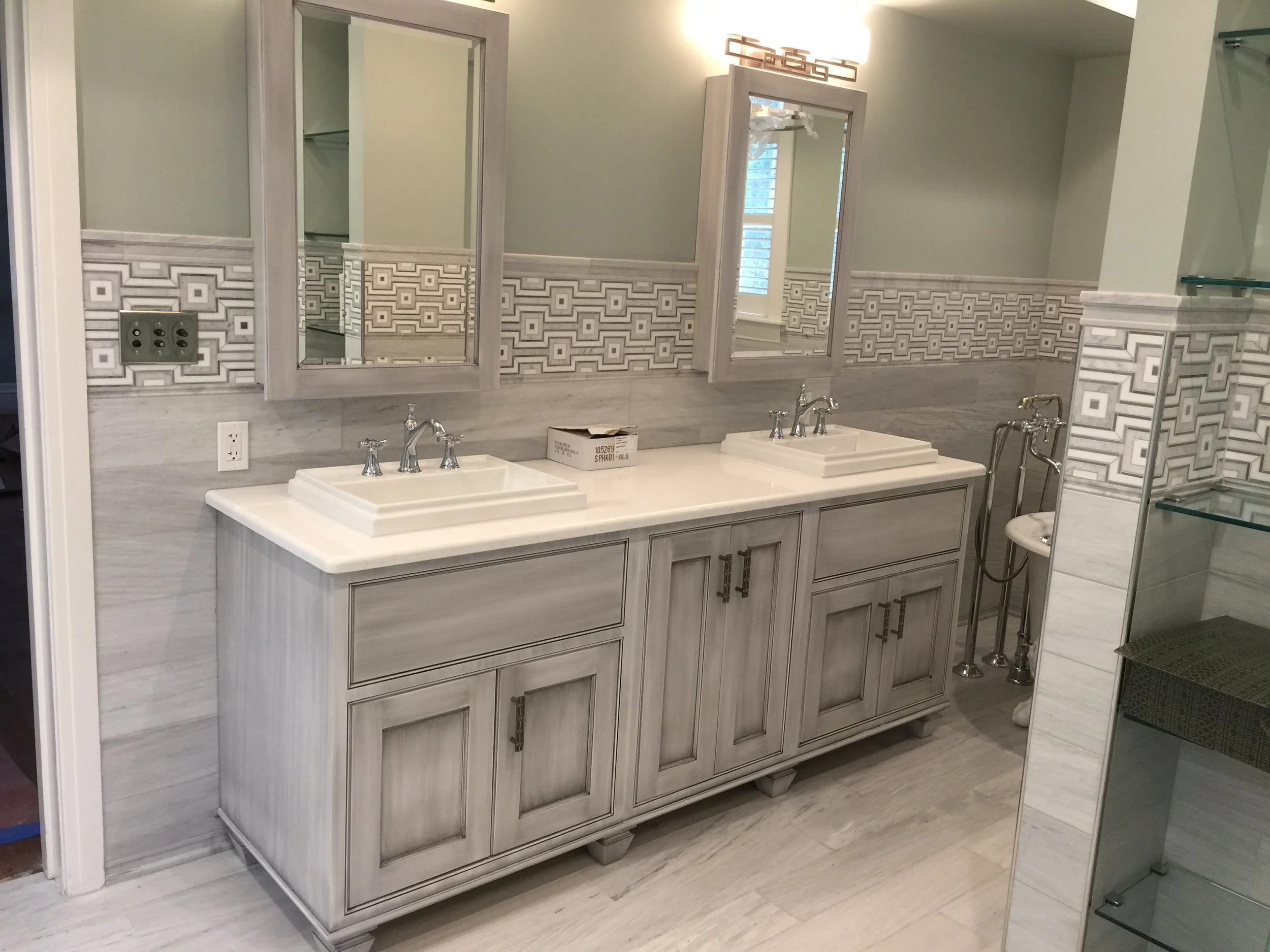 Renovated bathroom with double vanity and tile finishes at the Marshall University President's House.