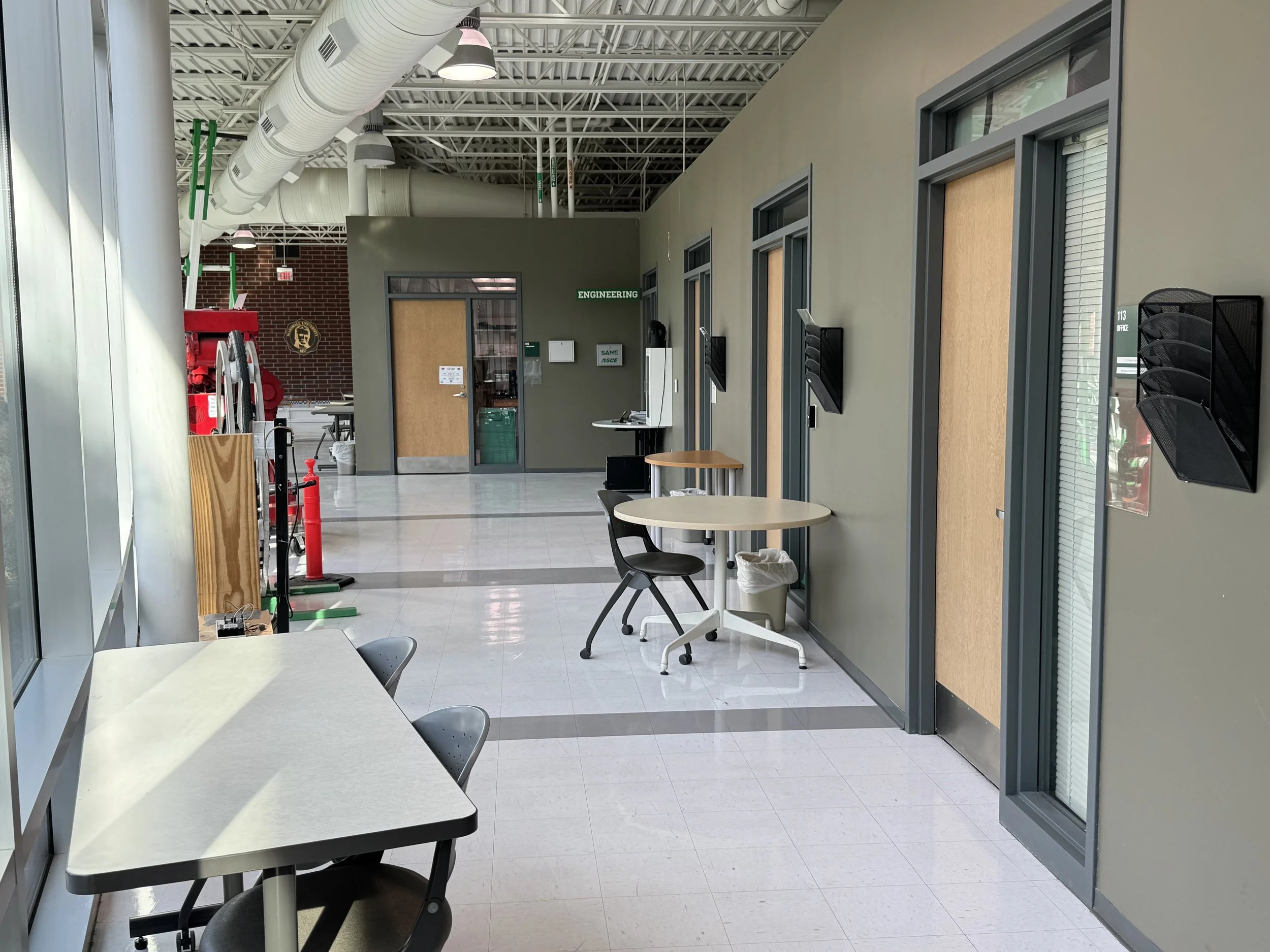 Engineering laboratory corridor with exposed ductwork and classroom entrances at Marshall University.