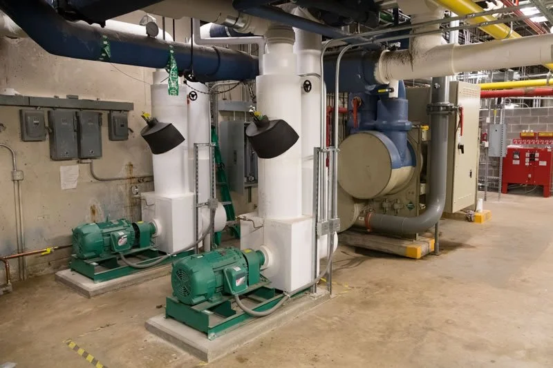 Pumps and insulated hydronic piping installed as part of the ACTC Main Building mechanical renovation.