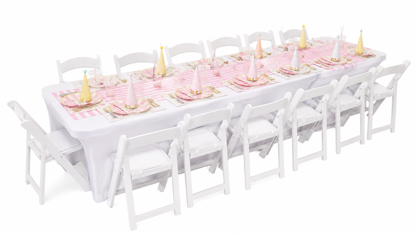Long table set for a celebration with pink and white decor, party hats, plates, and utensils, surrounded by white chairs.