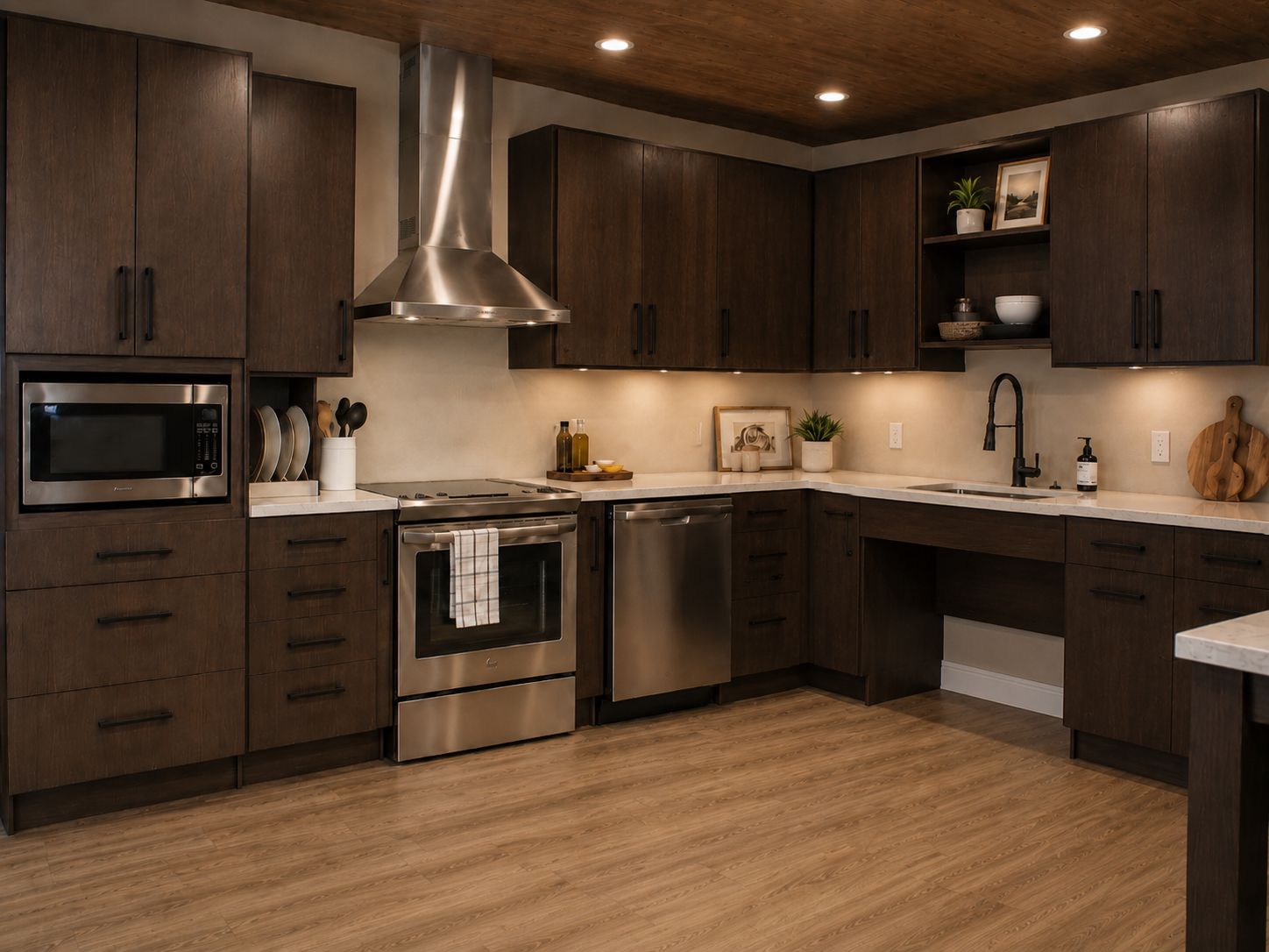Modern kitchen with dark wood cabinets, white countertop, stainless steel appliances, and hardwood flooring.