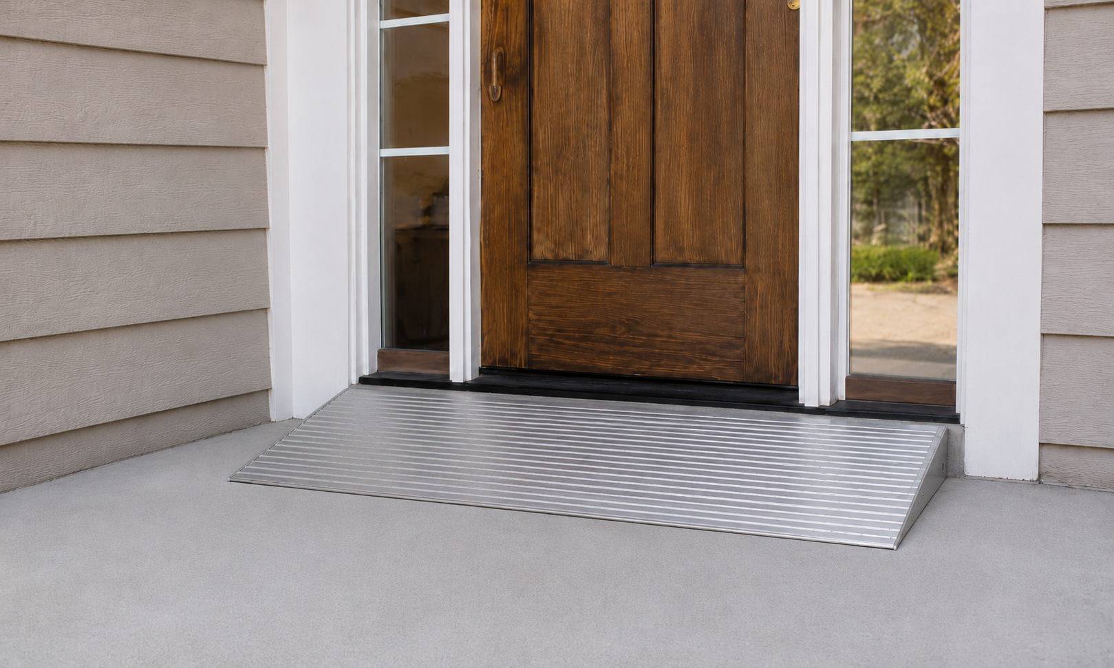 Front entrance with a wooden door, glass sidelight windows, and a metal ramp for accessibility.