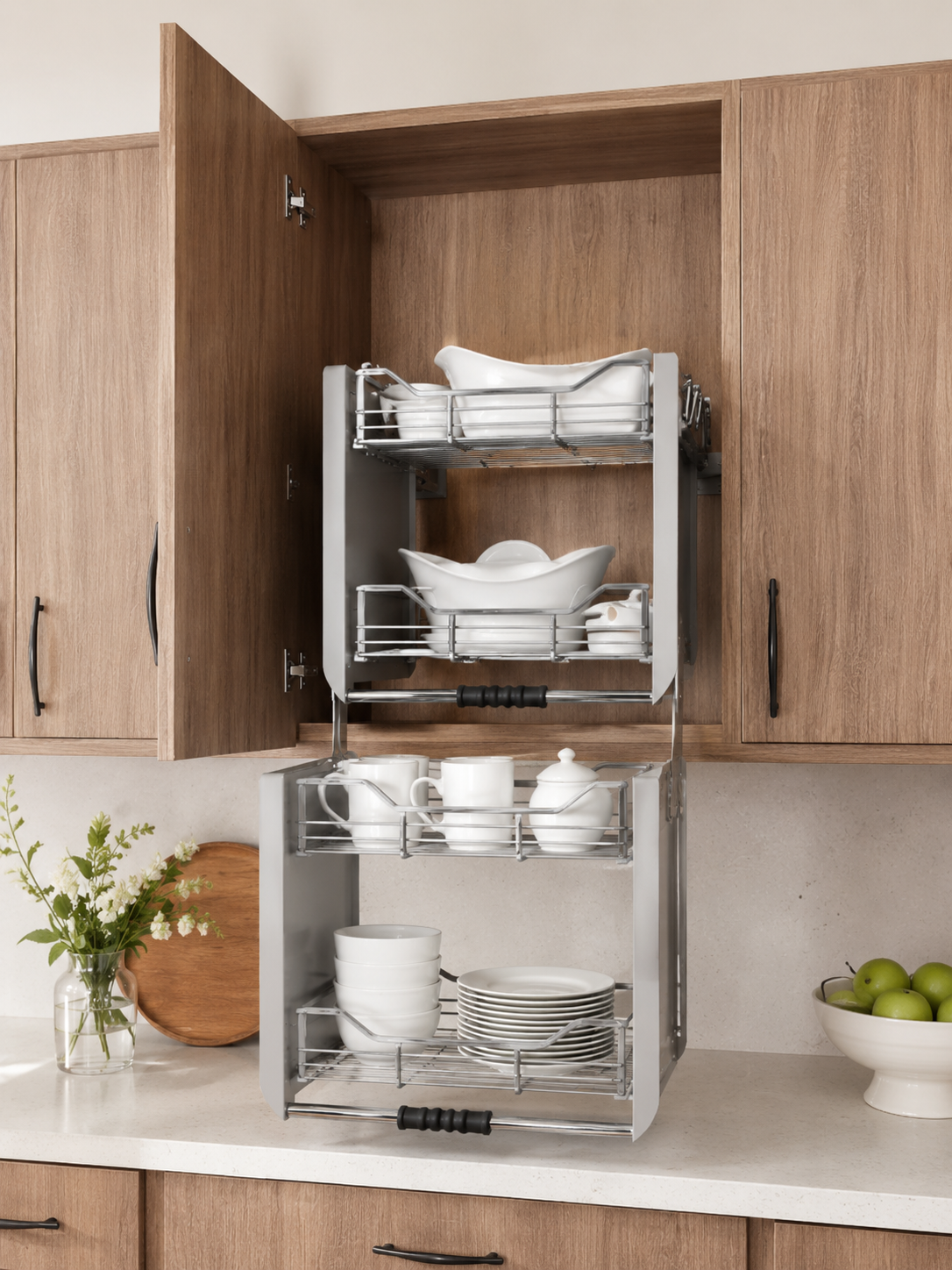 A kitchen cabinet with dishes stored on pull-out shelves, including plates, bowls, cups, and a teapot.