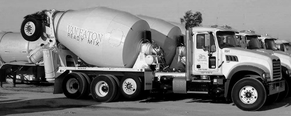 A concrete mixer truck labeled 'Vaneaton Ready Mix' parked outdoors with several similar trucks in the background.