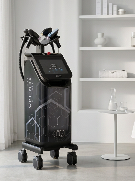 Medical aesthetic machine labeled 'INMODE' and 'OPTIMUS' in Wellness from Within in Knoxville with glassware and shelves in the background.