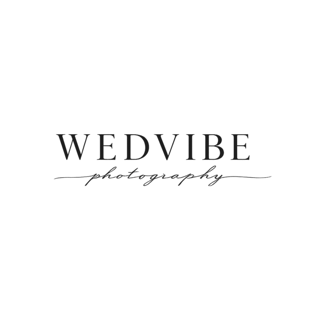 Black logo with a person taking a photograph and the text 'WEDVIBE photography' centered below it.