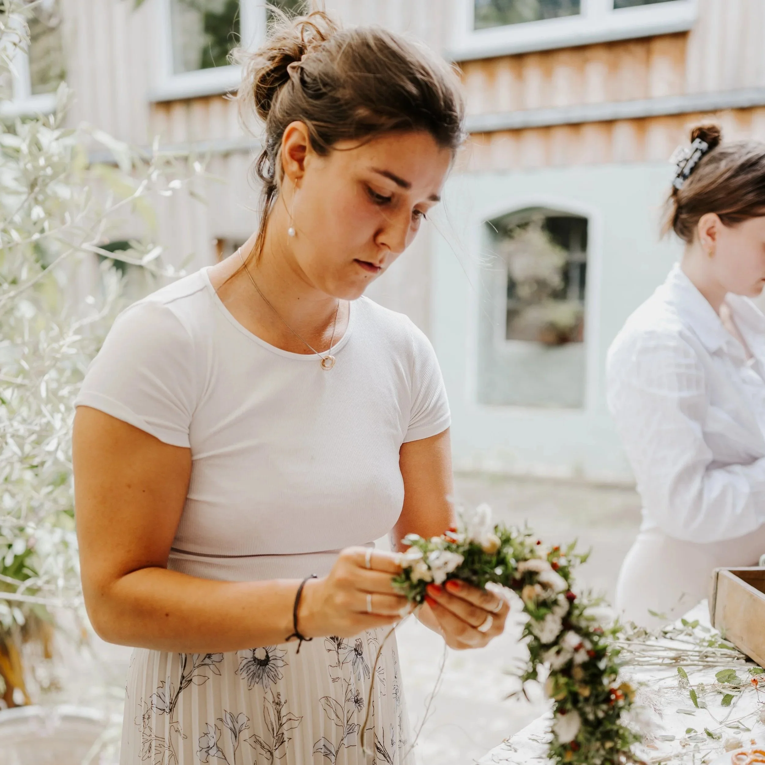 Workshopteilnehmerin beim Blumenkranzbinden, Idee für ruhigen JGA