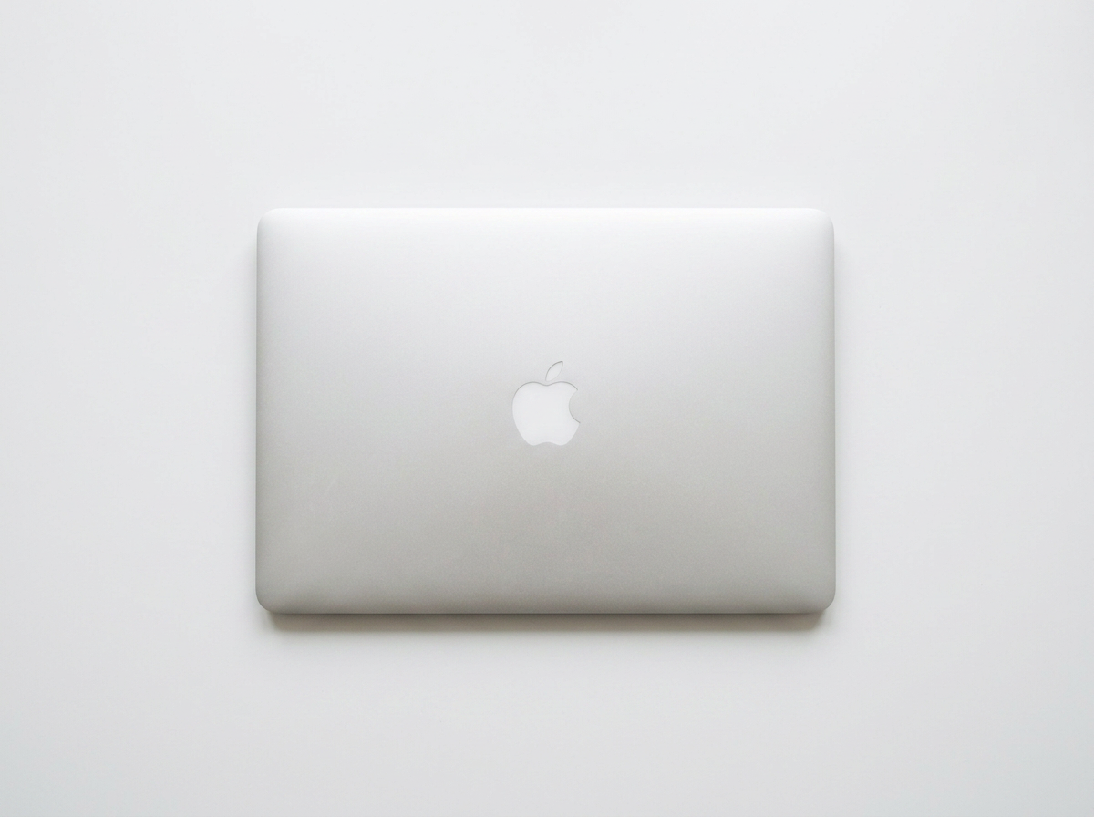 Silver Apple MacBook laptop closed on a white background.