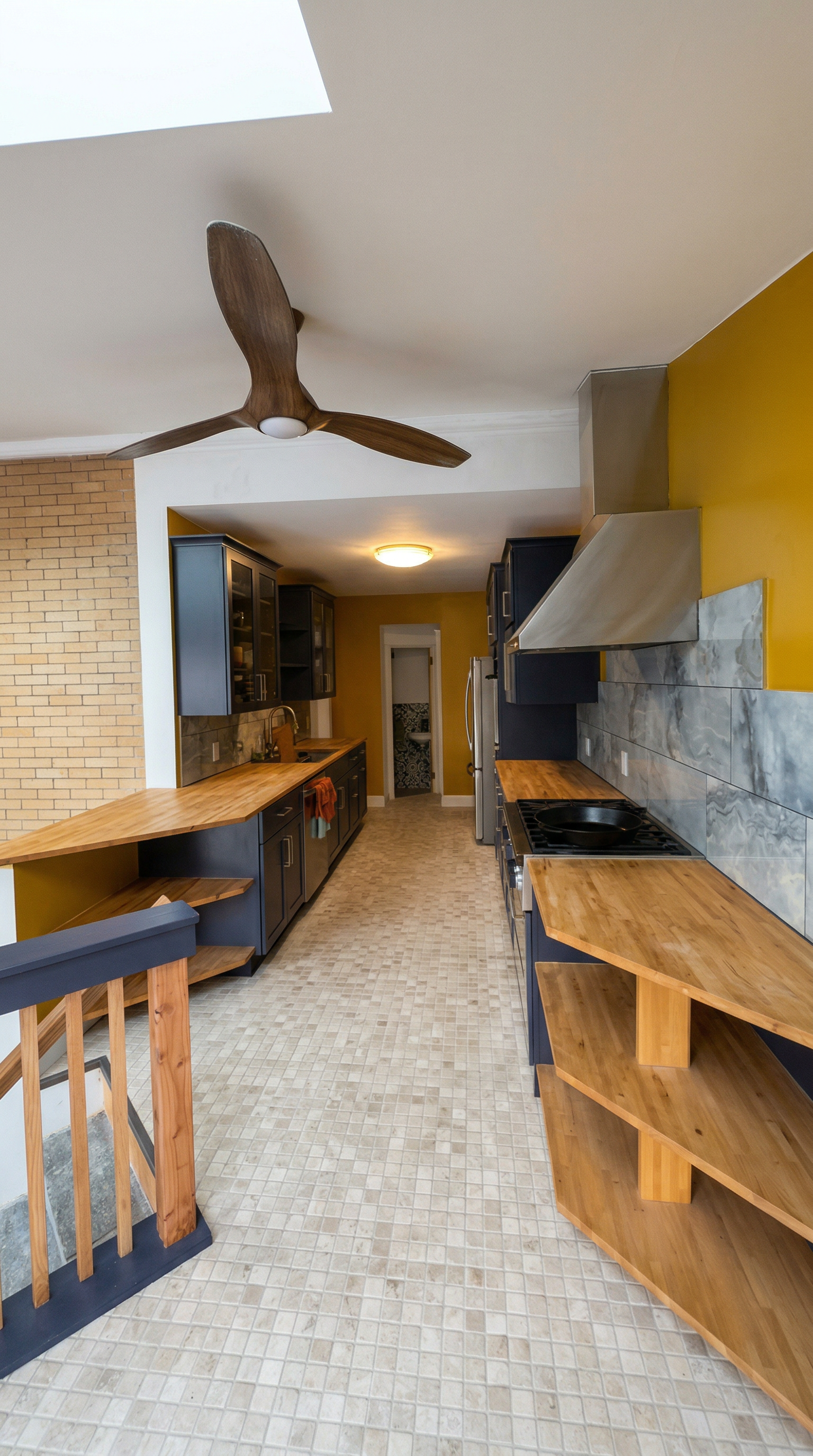 Kitchen with black cabinets, wooden countertops, yellow wall, stainless steel range hood, patterned backsplash, ceiling fan, and tiled floor.