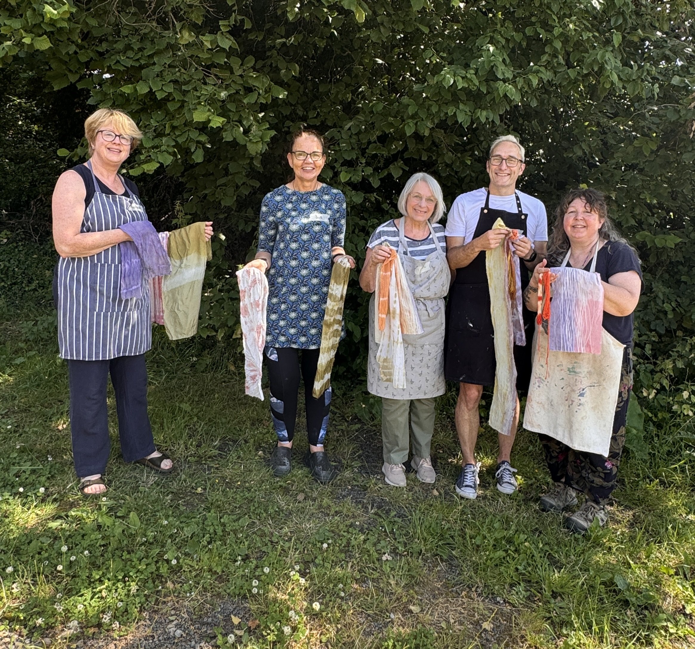 Creative workshop people holding their natural dyed fabric samples and tie dye