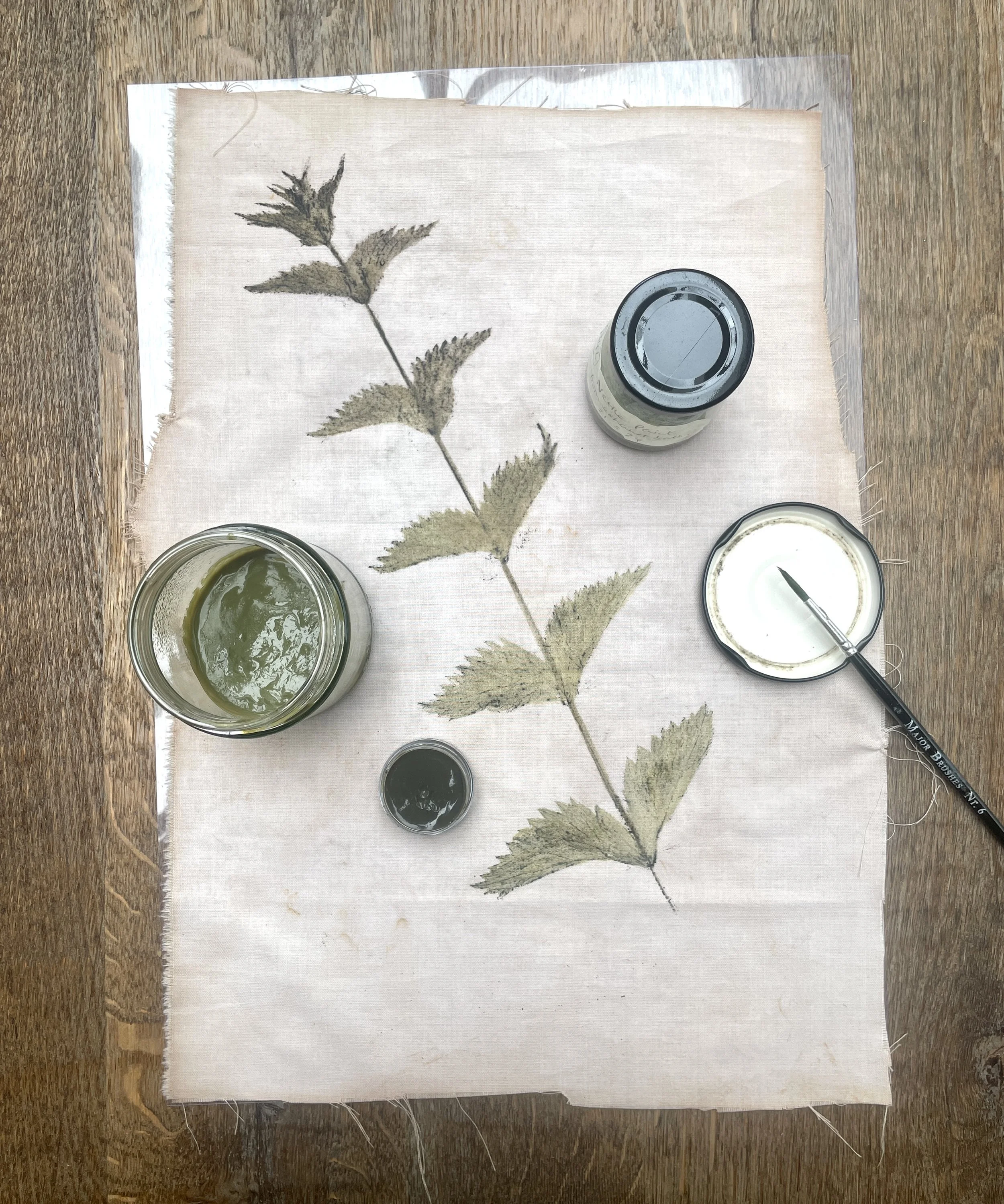 Monoprint of a nettle handprinted in nettle lake pigment