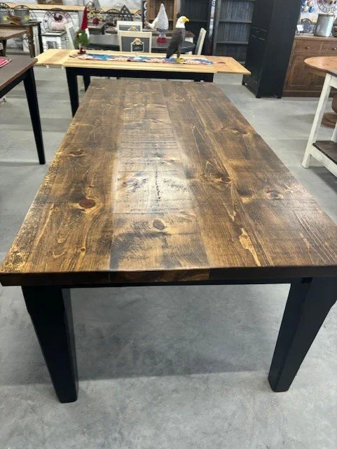 Tapered black base with stained top table with 2 inch thick top