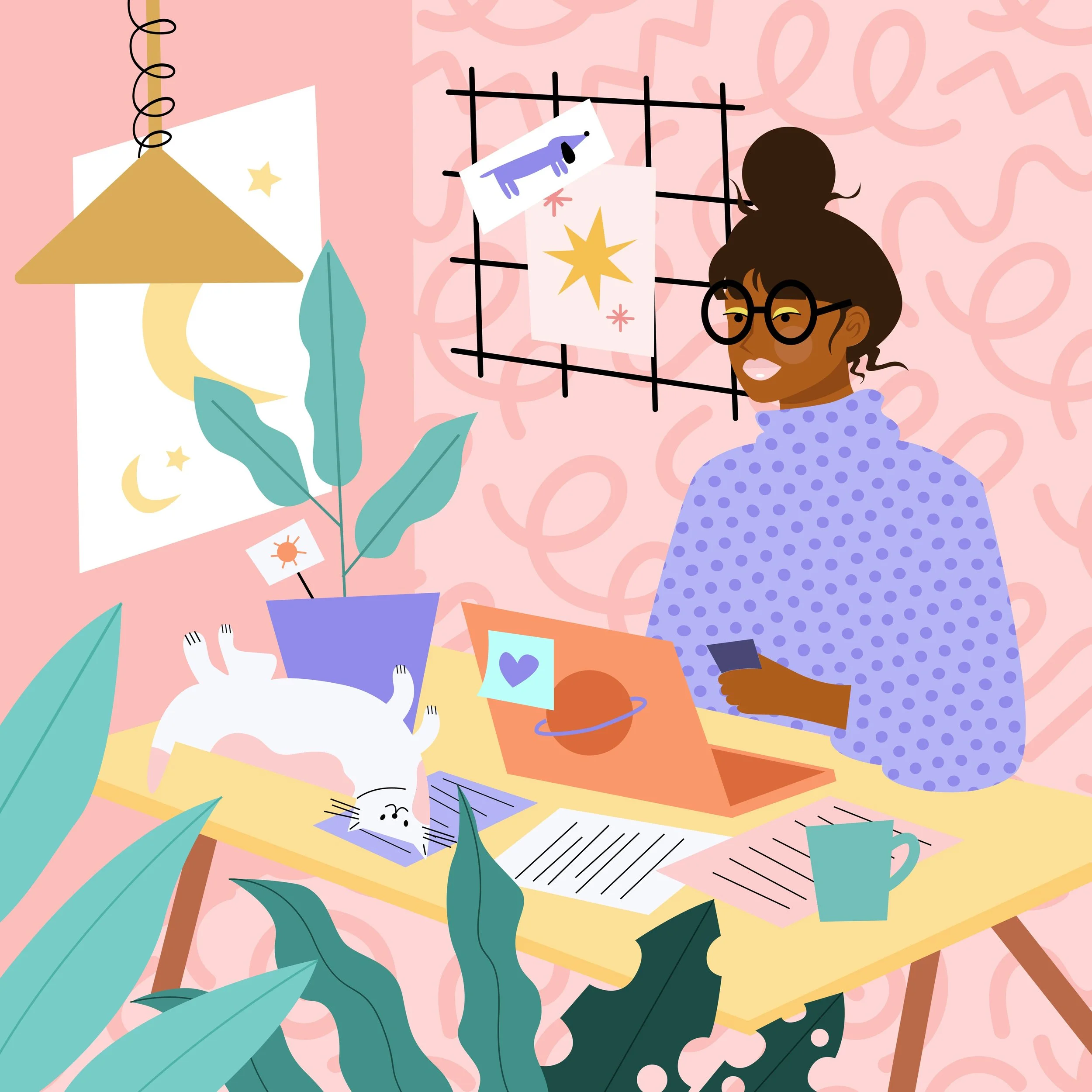 A woman with glasses and brown hair in a bun, sitting at a yellow table, smiling while looking at her phone. There are framed pictures and artwork on the pink patterned wall behind her, including drawings of a dog, stars, and abstract shapes, with various papers, a potted plant, and a cup on the table.