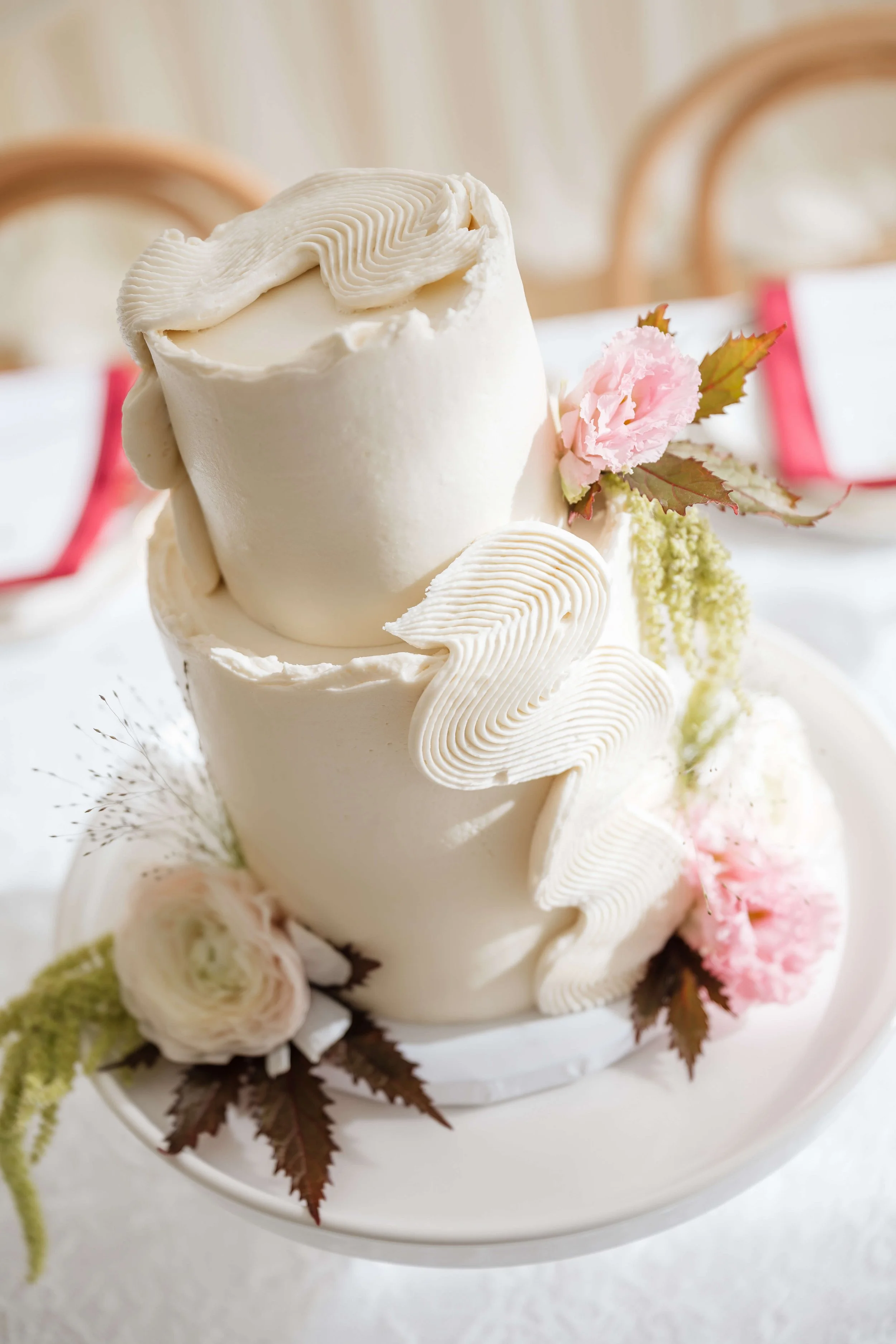 Modern Buttercream wedding cake with burgundy and blush flowers