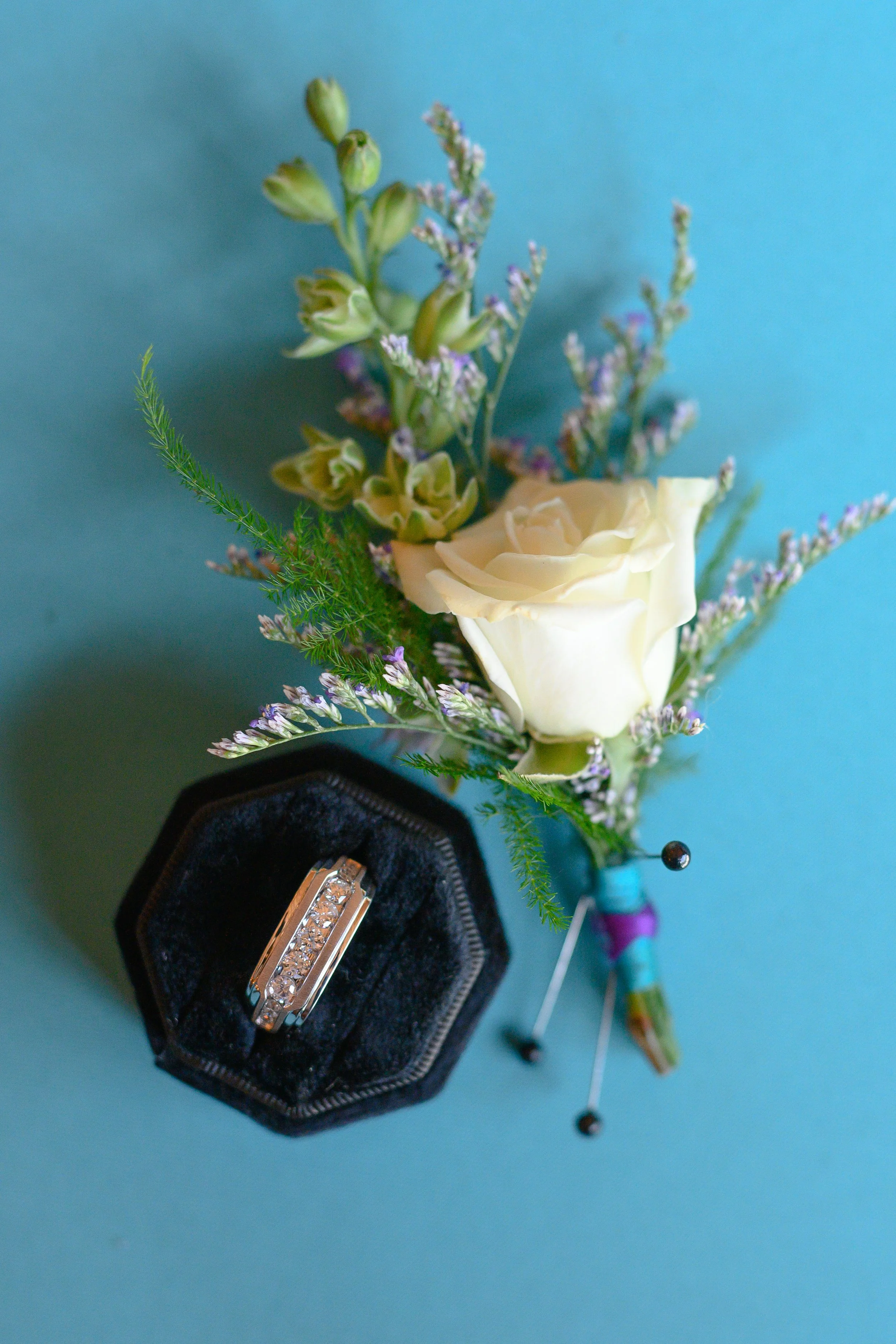 Colorful boutonierre and groom's ring at a Tacoma wedding