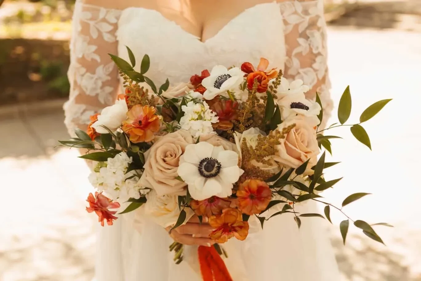 Bride holding a colorful bridal bouquet at a Seattle Wedding Hall by Love Letter Floral and Events